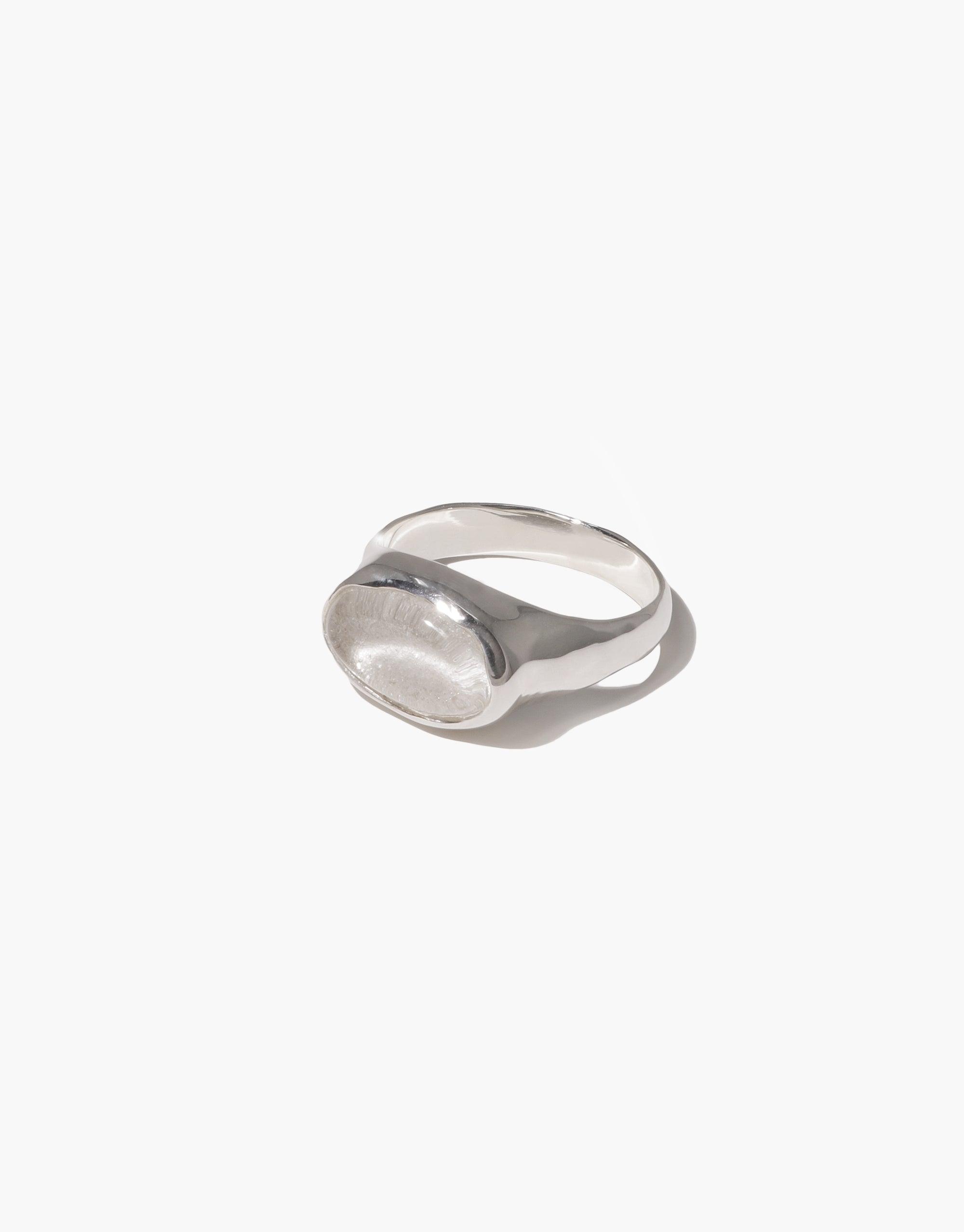 Oval Sculpture Ring featuring a sleek silver band with a smooth, oval-shaped clear glass charm. Handcrafted eco-friendly jewelry made from upcycled glass bottles. Minimalist design perfect for everyday wear. Sustainable and stylish accessory by CLED.
