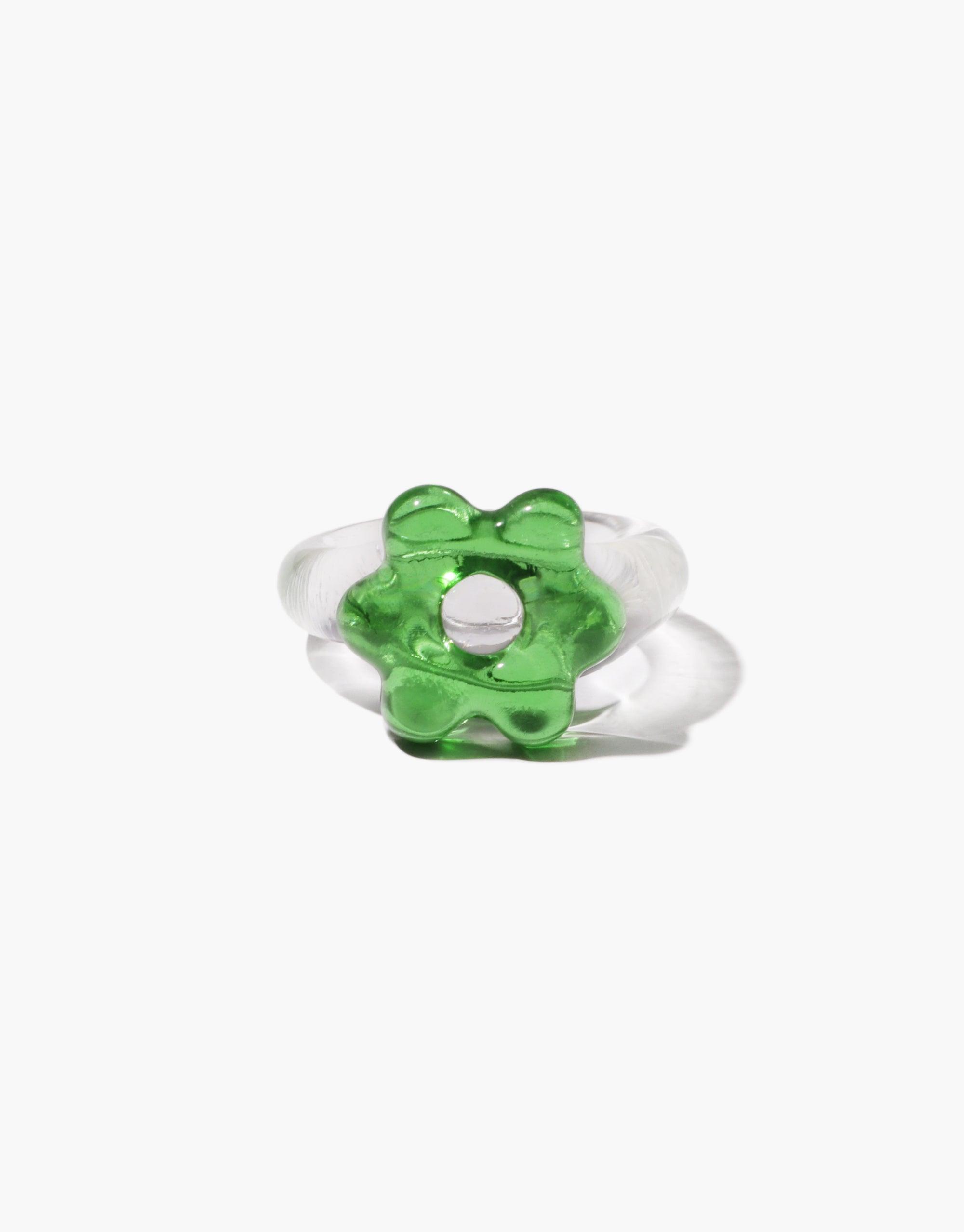 Avens Icon Ring | Large featuring a whimsical green flower-shaped glass element set on a clear band. Unique and eye-catching design showcasing recycled materials. Stylish and eco-friendly statement piece for fashion-forward individuals. CLED