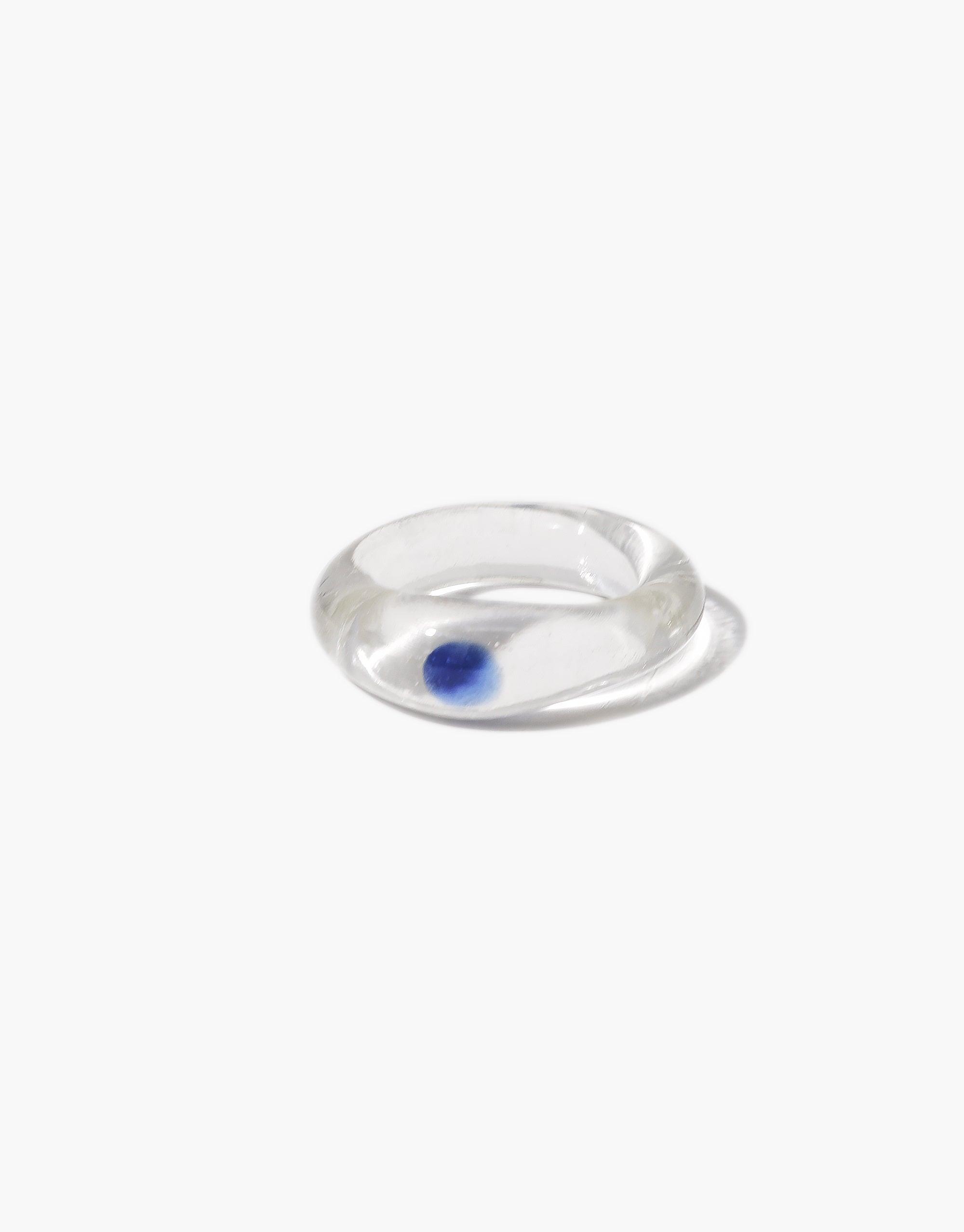 Elegant transparent ring with a captivating blue sphere enclosed within, showcasing the unique Blue Moon Ring design. This enchanting piece embodies celestial beauty and mystical allure, perfect for those seeking a touch of magic in their jewelry. Blue Moon Ring by CLED