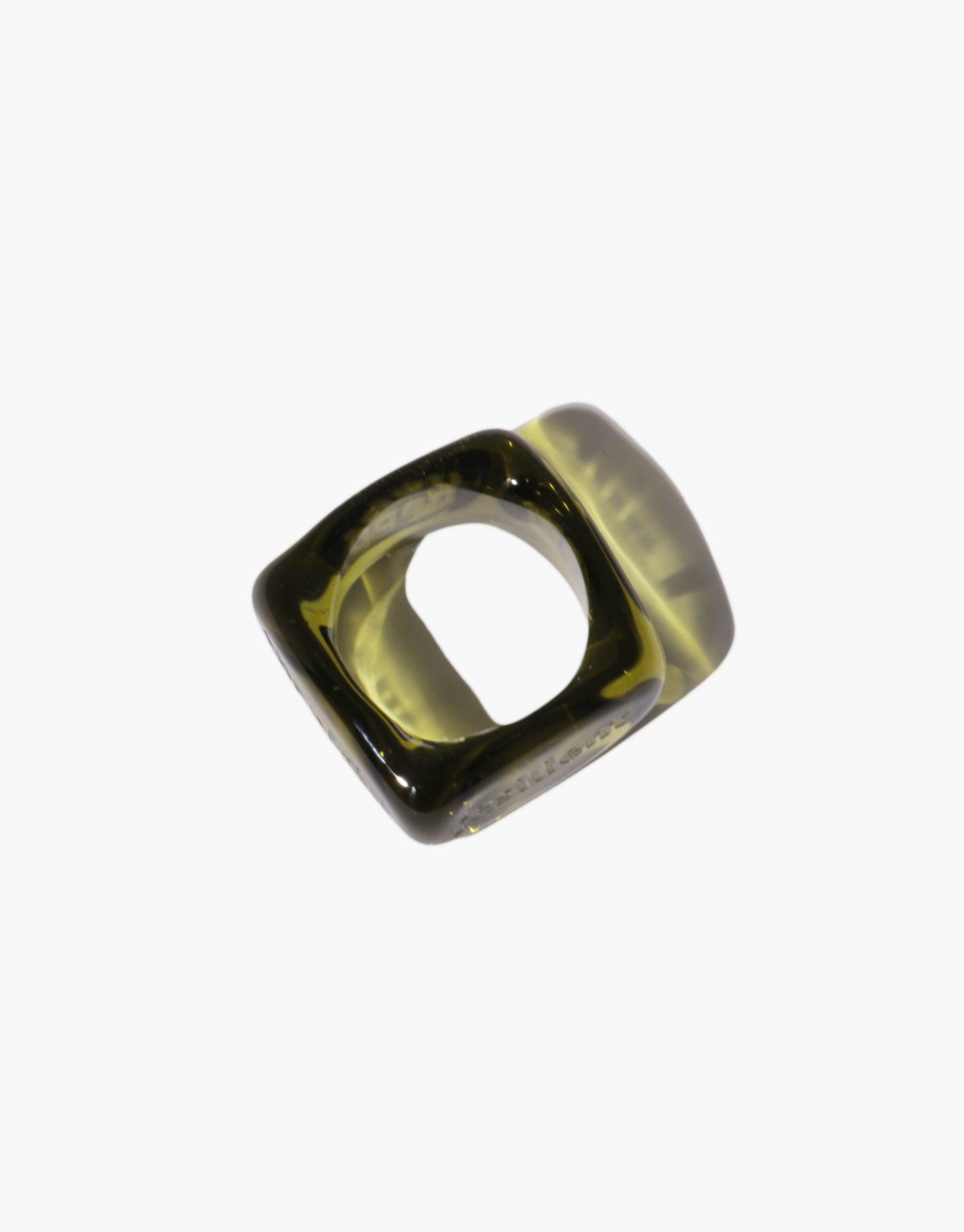 Unique square-shaped glass ring with rounded interior, showcasing a translucent olive-green color. Dice Ring | I am featuring personalized engraving for daily affirmations and reminders. Molten glass design adds quirky excitement to any outfit. CLED