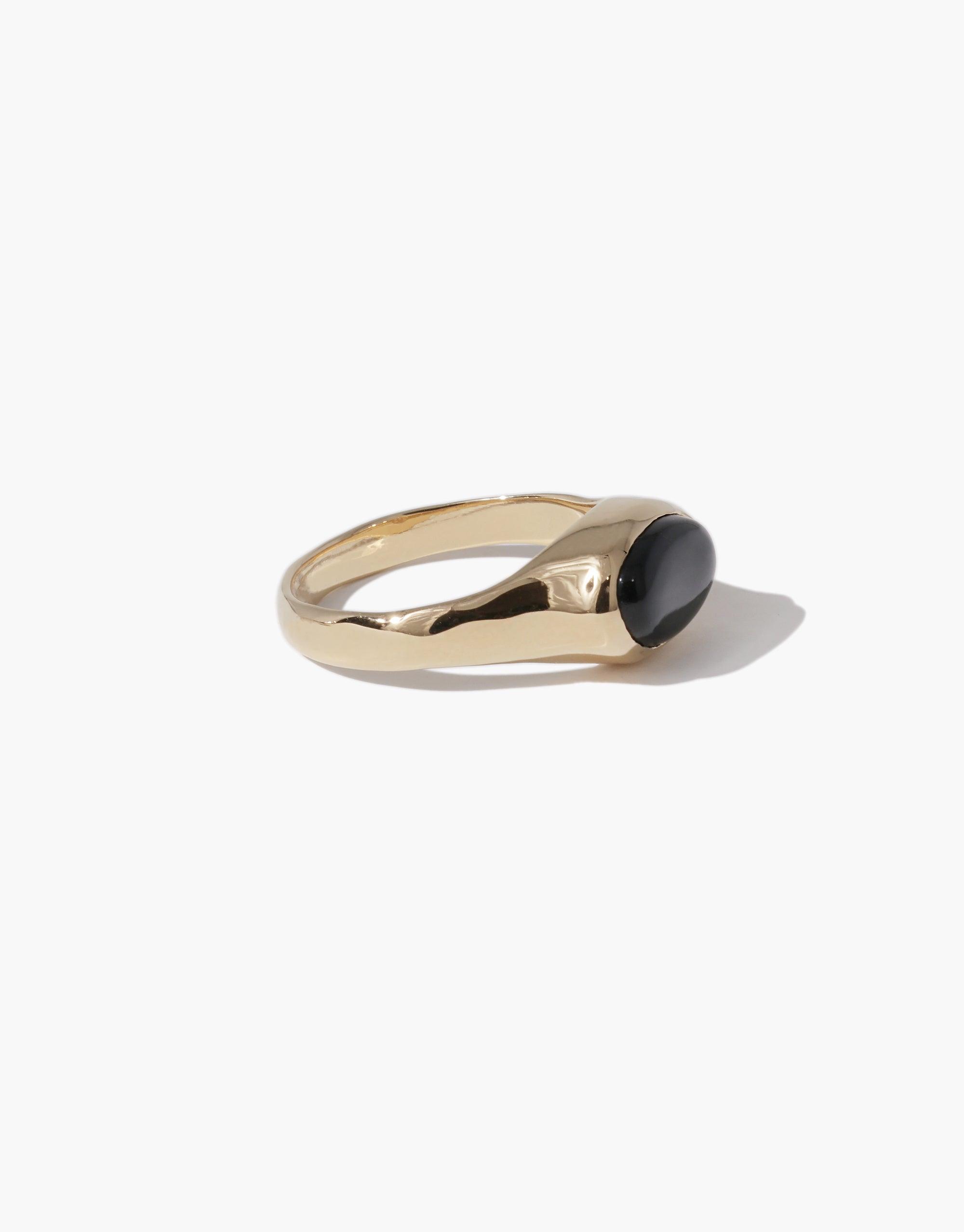Oval Sculpture Ring featuring a sleek gold-toned band with a smooth black oval eco gem centerpiece, showcasing sustainable luxury design. Handcrafted statement jewelry piece by CLED.