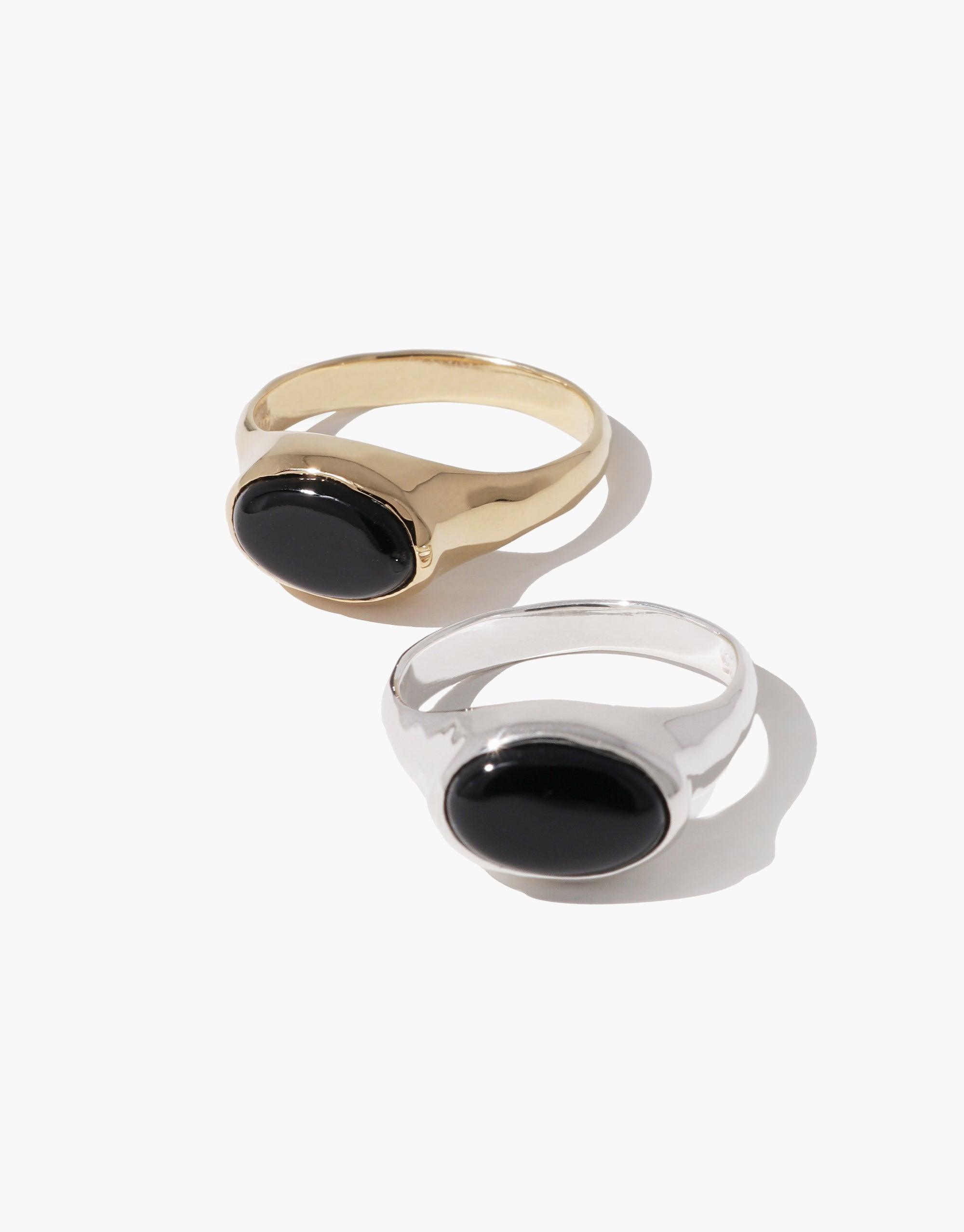 Oval Sculpture Ring featuring gold and silver bands with black oval eco gems, showcasing sustainable elegance in jewelry design. Handcrafted charm-inspired piece reflecting earth's beauty. Versatile and unique accessory by CLED.