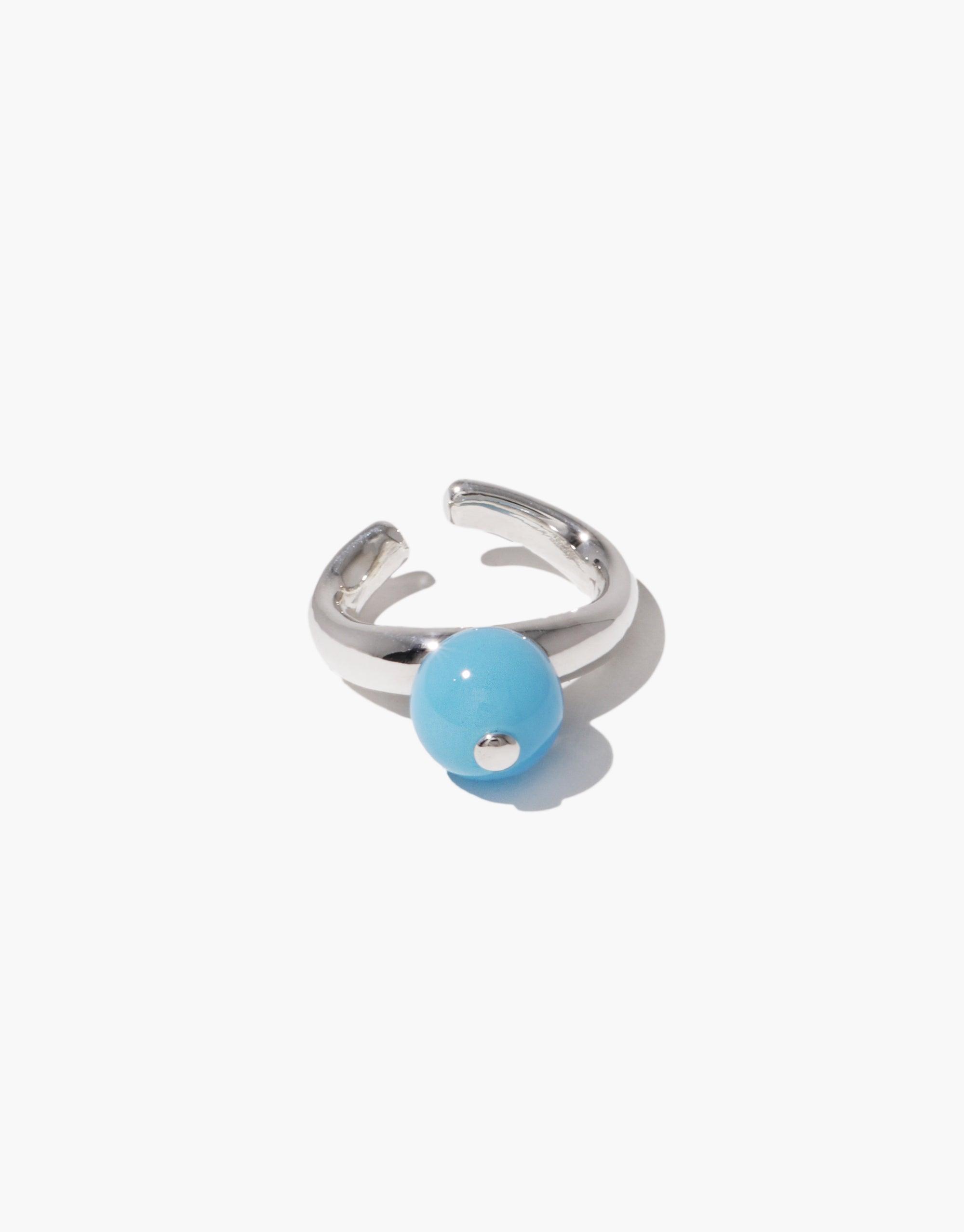 Pea Ear Cuff | Small featuring a silver-toned adjustable band with a light blue spherical accent, inspired by nature's organic shapes and growth. Elegant and minimalist design for versatile wear. CLED