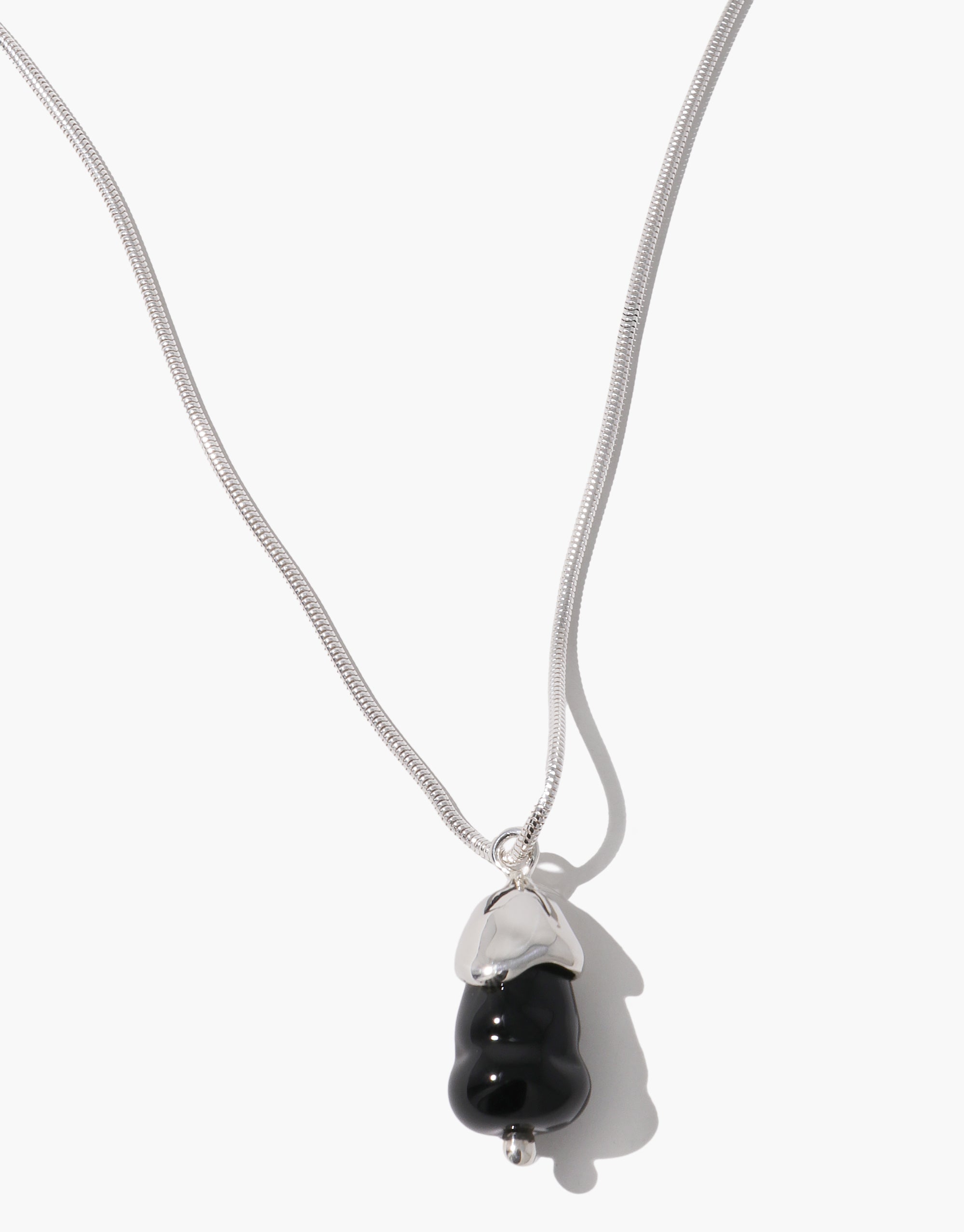 Solace Drop Necklace with sleek black glass pendant on silver snake chain, featuring minimalist design by CLED