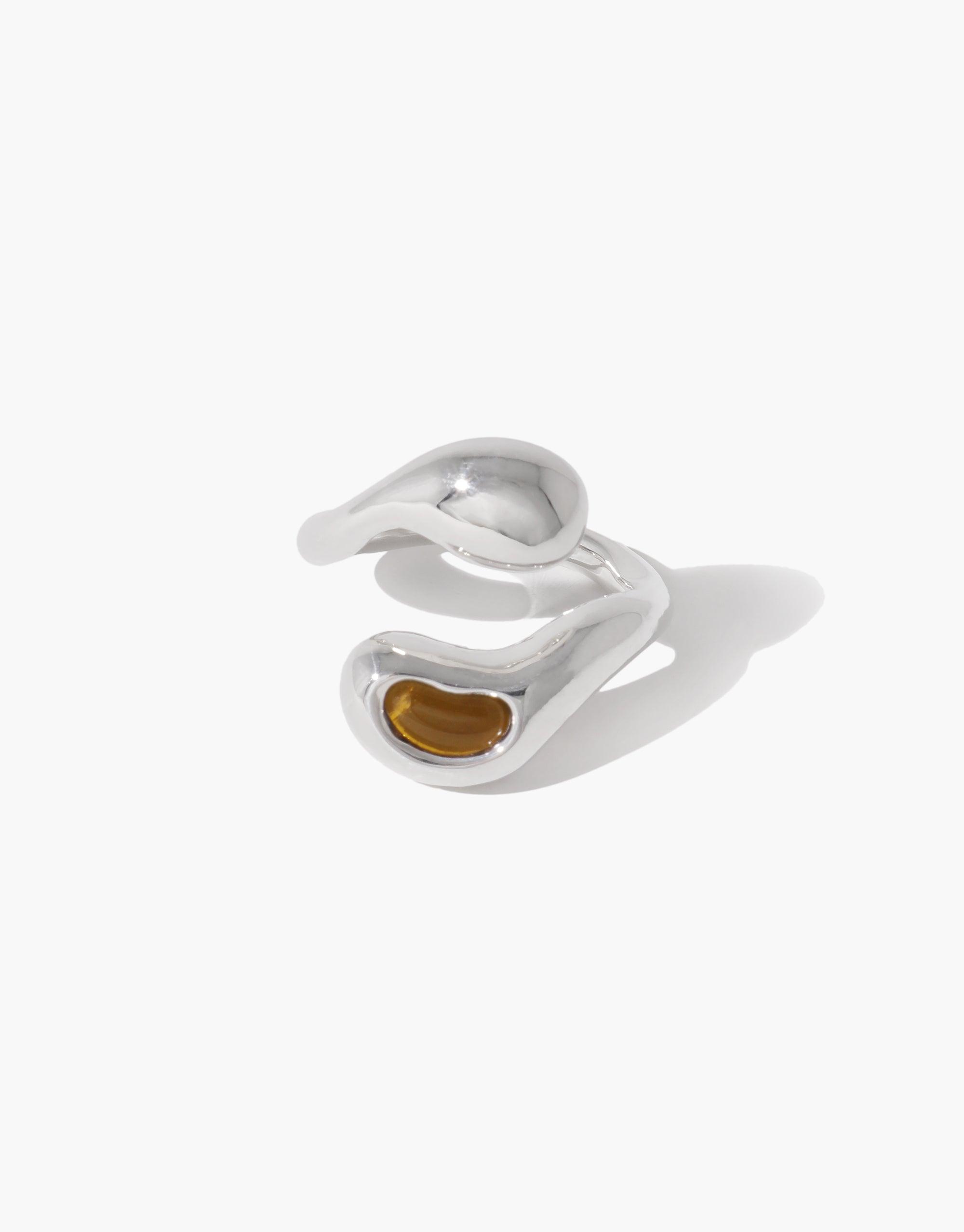 Sprout Ring featuring a silver band with a brown stone, inspired by nature's organic pea shapes and crafted from repurposed materials, reflecting growth and transformation.