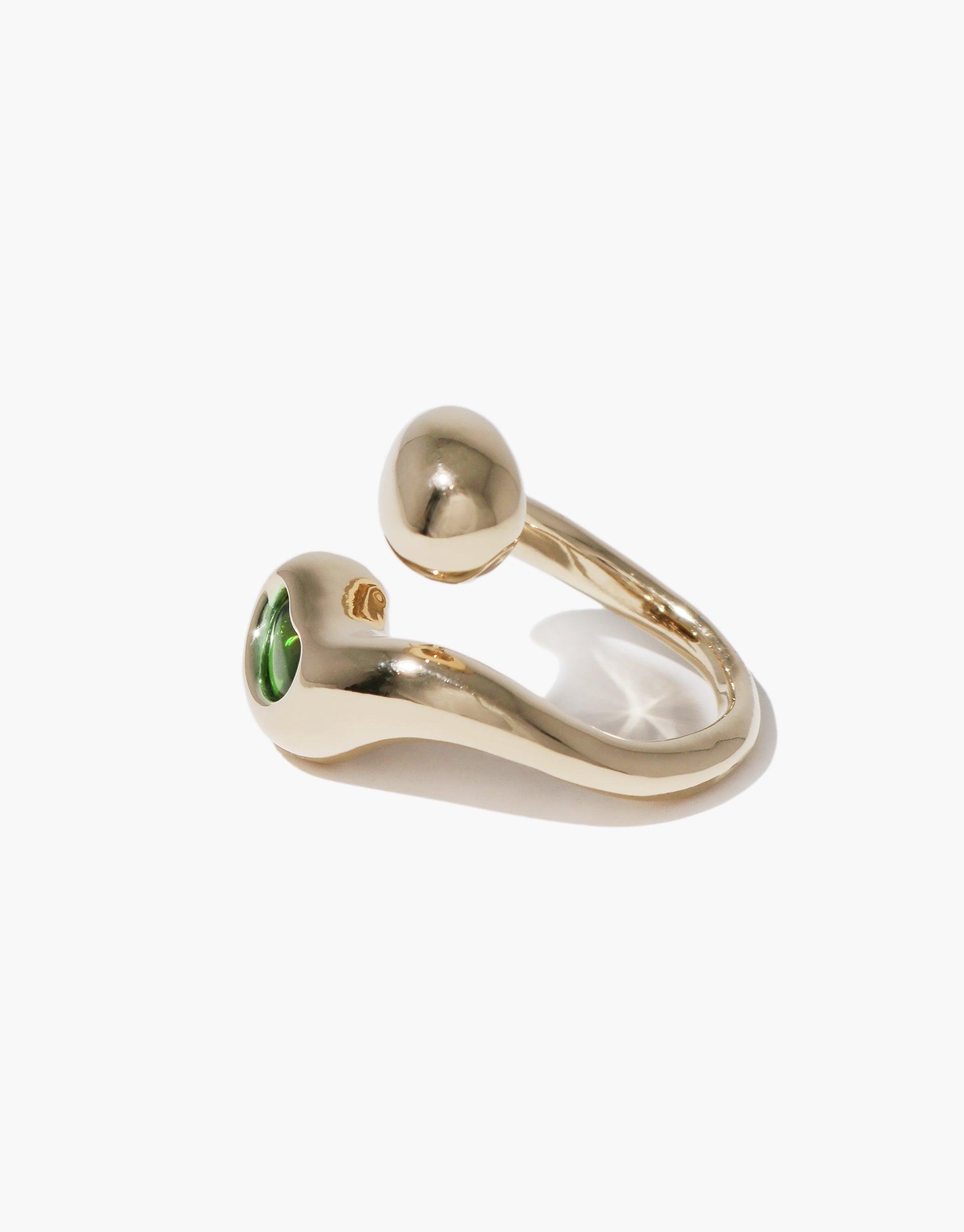 Sprout Ring: A gold ring featuring a striking green stone, inspired by nature's growth and transformation, reflecting CLED's eco-conscious design ethos with its organic shape and intricate detailing.