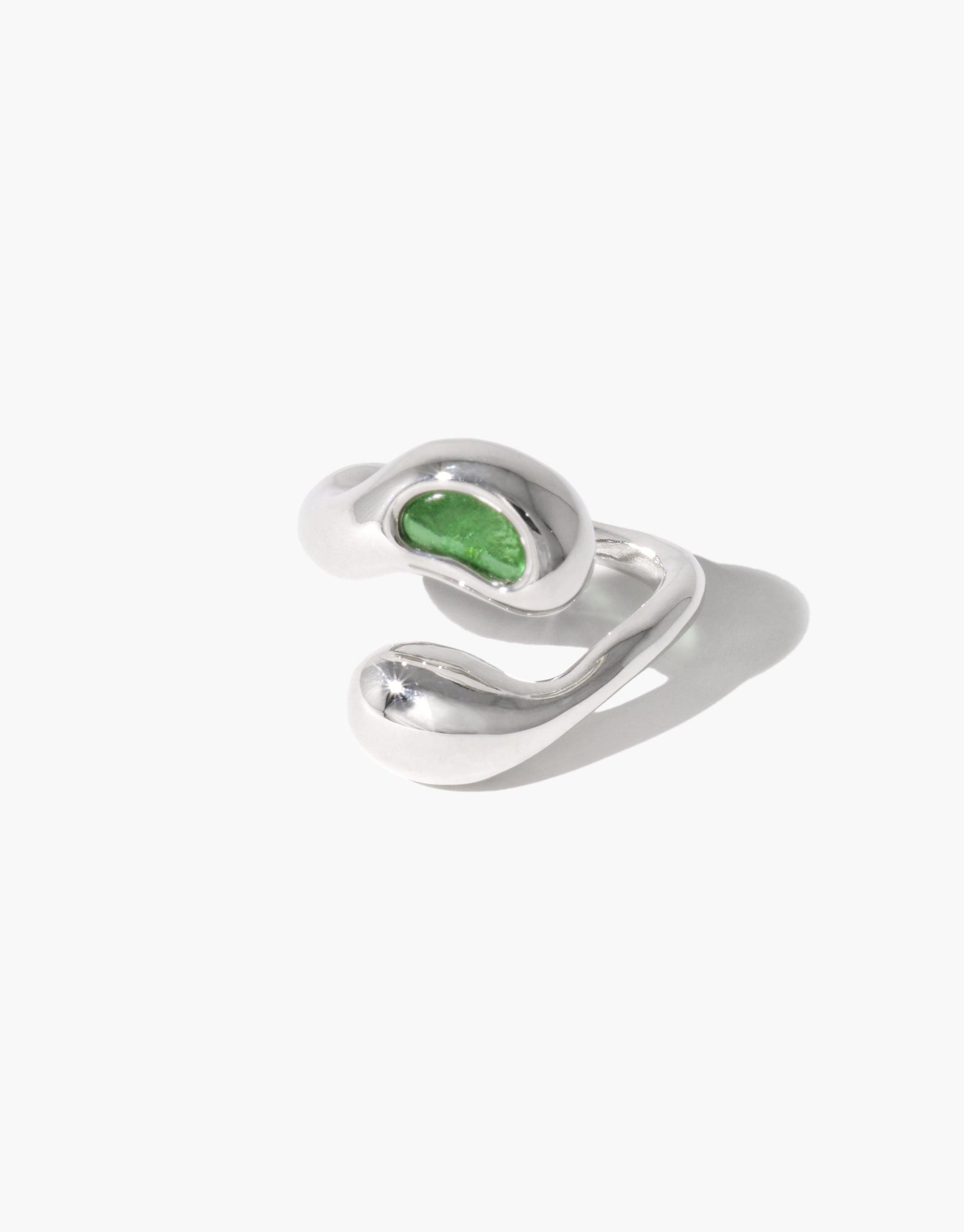 Sprout Ring featuring a silver band with a green stone, inspired by nature's organic pea shapes and crafted from repurposed materials, reflecting growth and transformation.