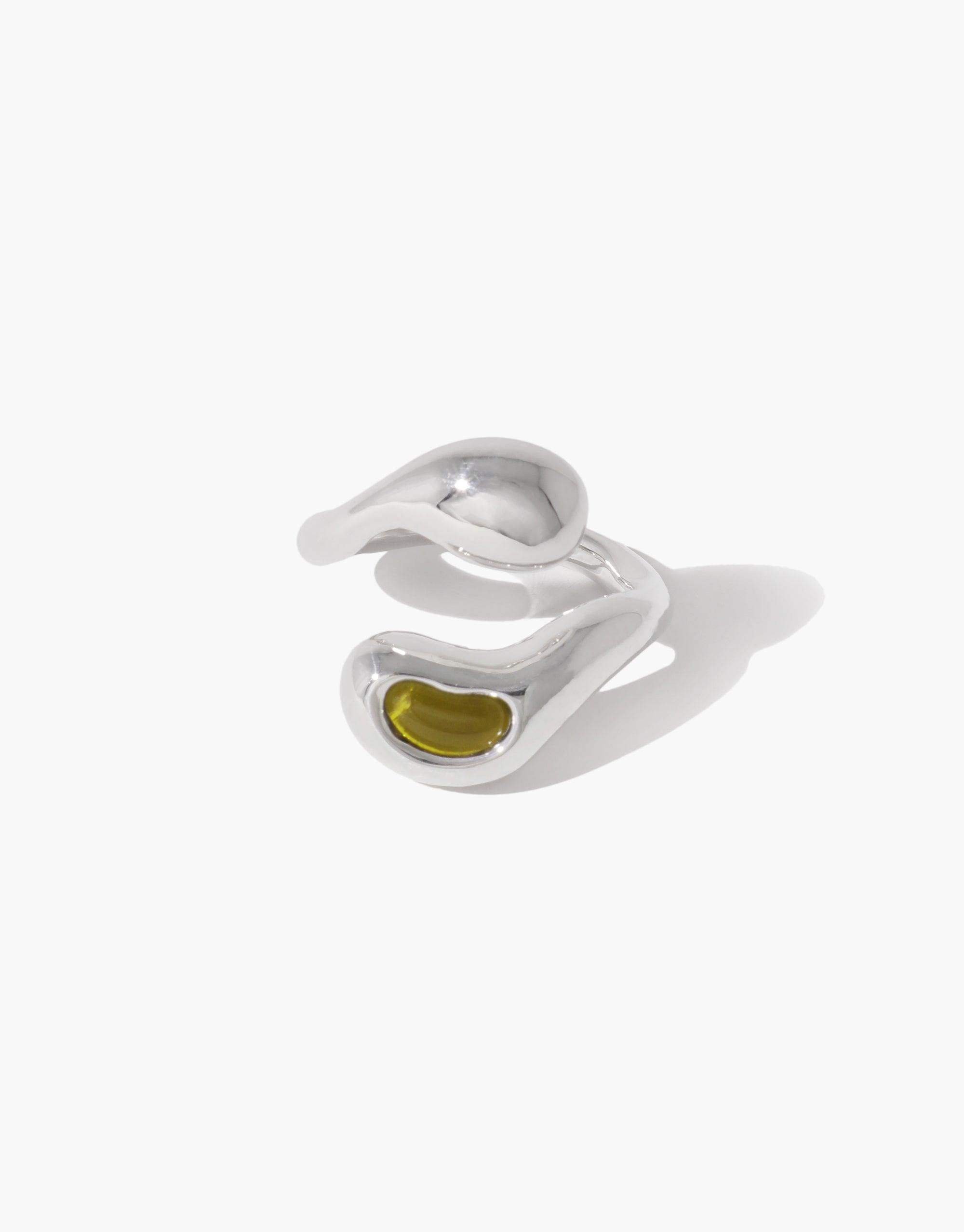 Sprout Ring featuring a silver band with a olive stone, inspired by nature's organic pea shapes and crafted from repurposed materials, reflecting growth and transformation.