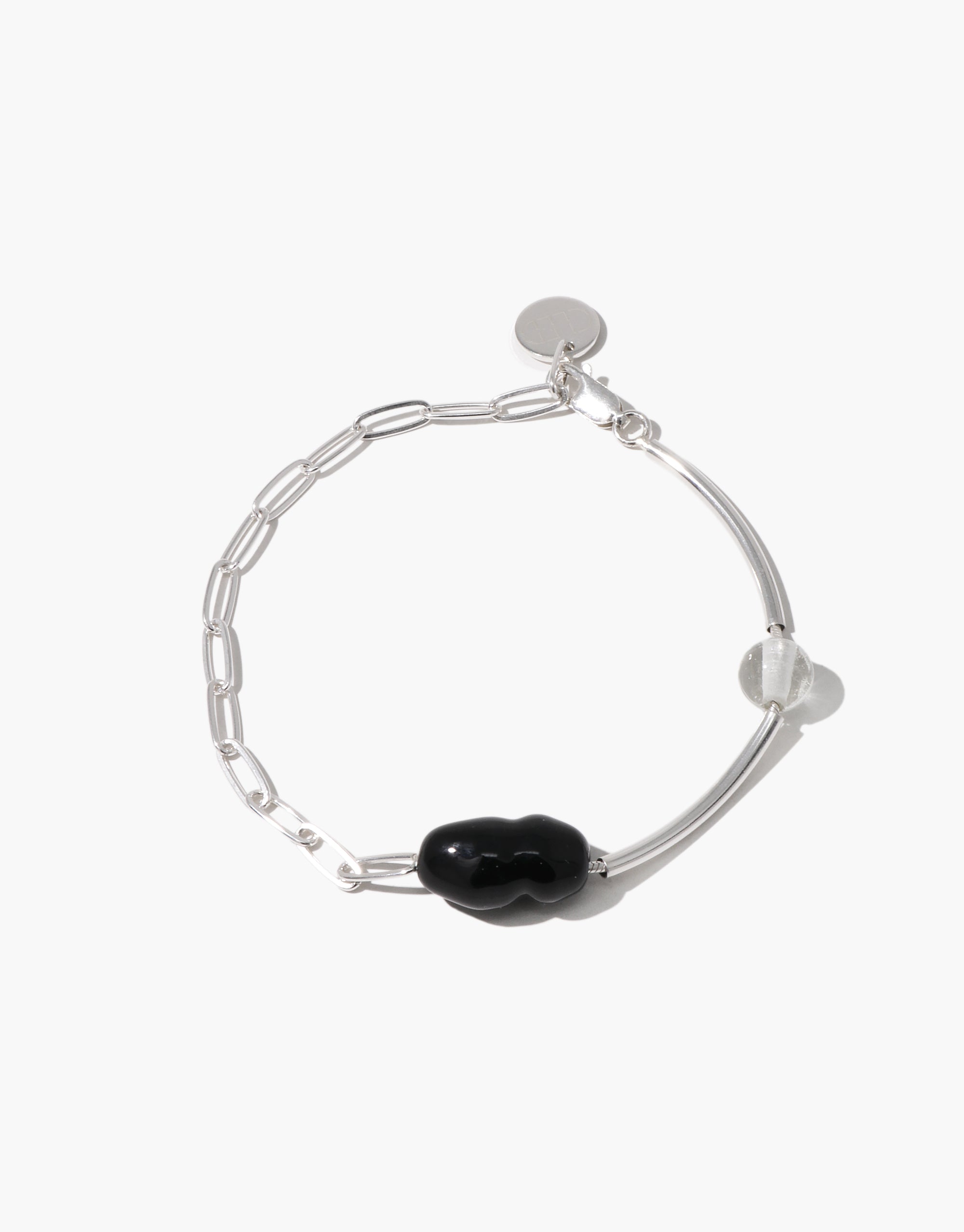 Silver bracelet featuring a black organic-shaped Eco Gem and a clear round bead, with a mix of chain and curved bar elements