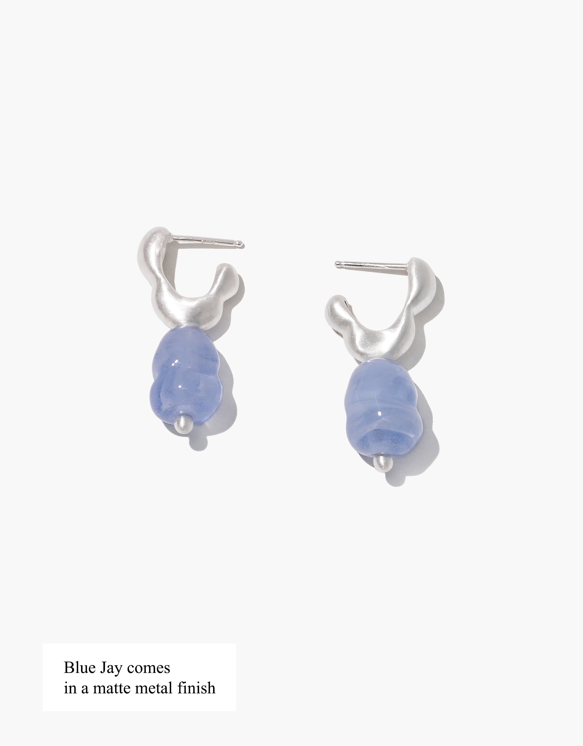 Flow Drop Hoop Earrings featuring sculptural silver hoops with light blue glass drops, handcrafted sustainable jewelry by CLED