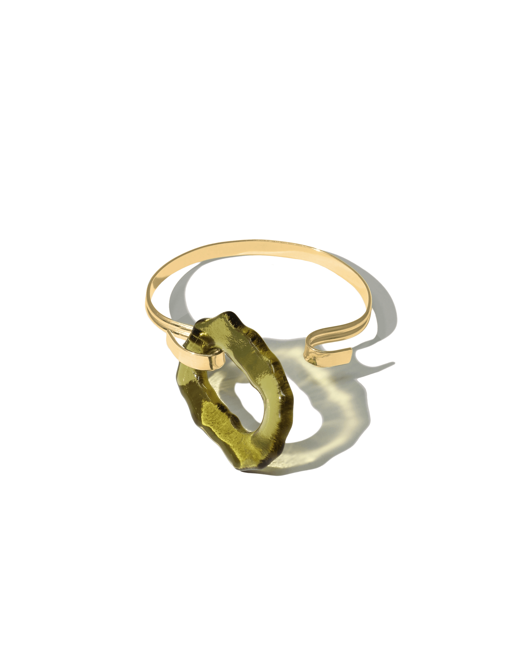 Canyon Hook Bracelet featuring an organic oval-shaped eco gem in olive green, handcrafted from repurposed glass bottles. Gold vermeil double bands form a unique hook closure, inspired by canyon terrain. Sustainable and stylish accessory by CLED.