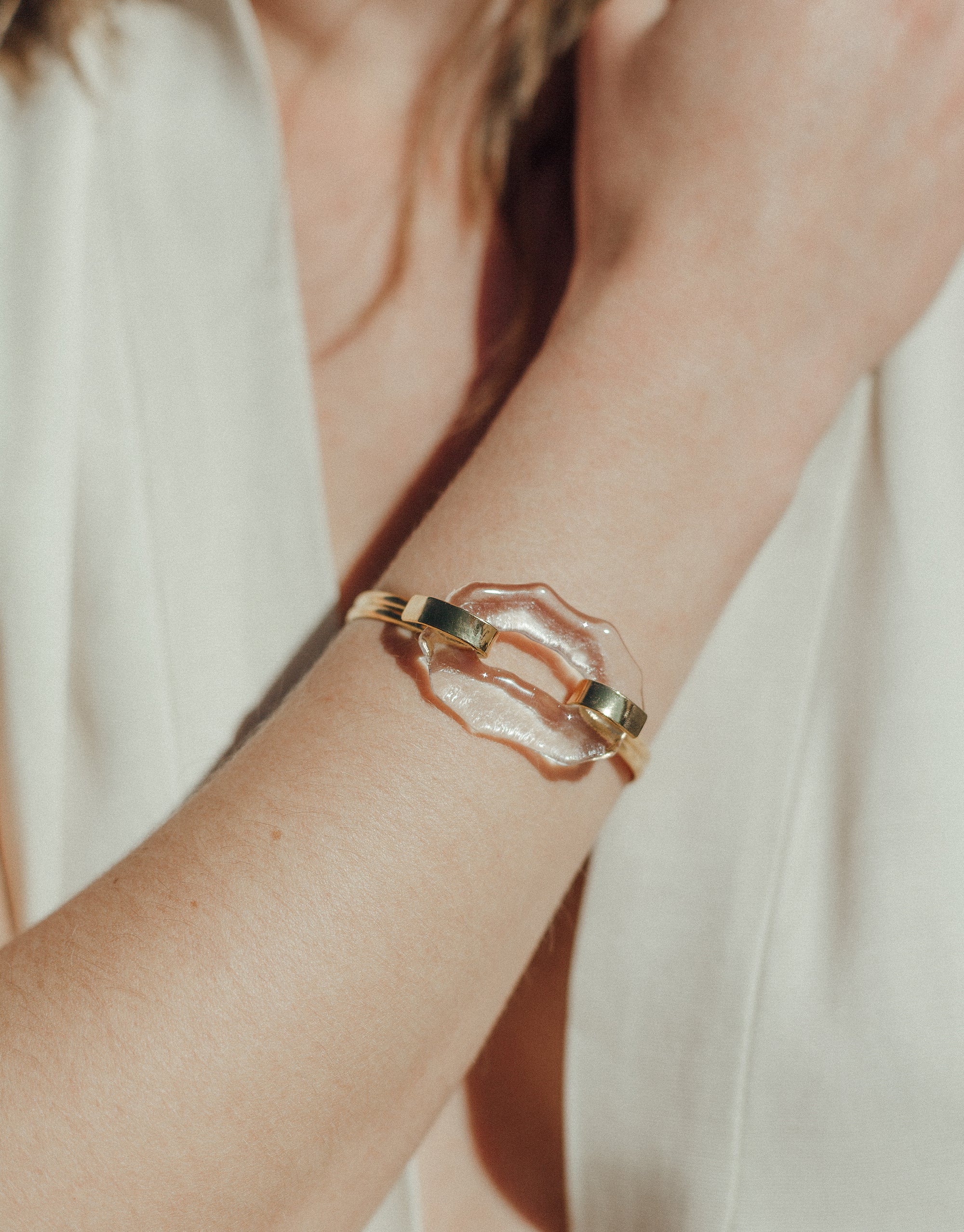 Canyon Hook Bracelet featuring a unique organic glass shape with double gold bands, inspired by canyon terrain. Handcrafted eco-friendly bracelet made from repurposed glass bottles, perfect for everyday or dressy wear. Showcasing sustainable luxury jewelry by CLED.