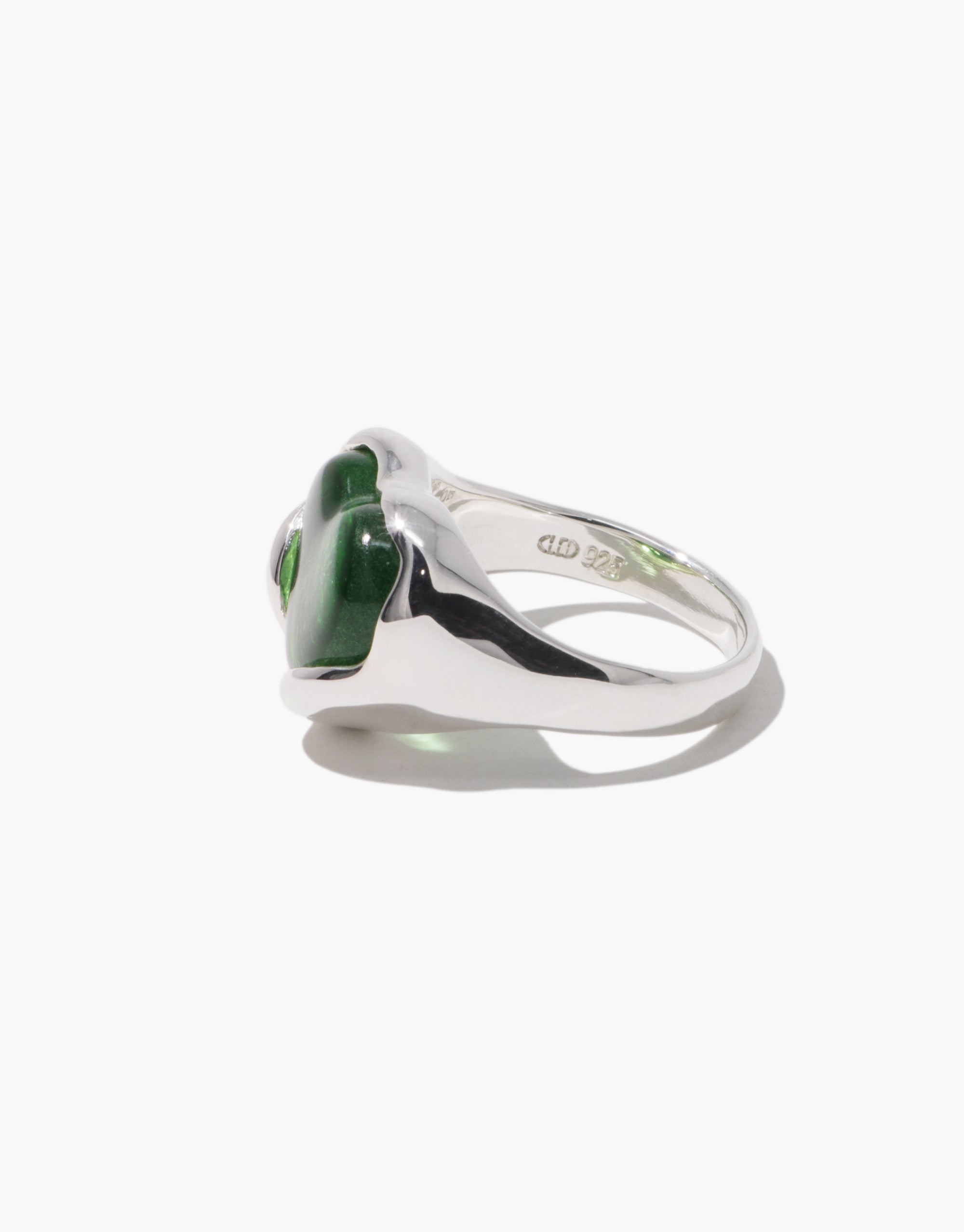 Side angle of a silver ring showcasing a deep green heart-shaped Eco Gem with engraved "CLED 925" inside the band.