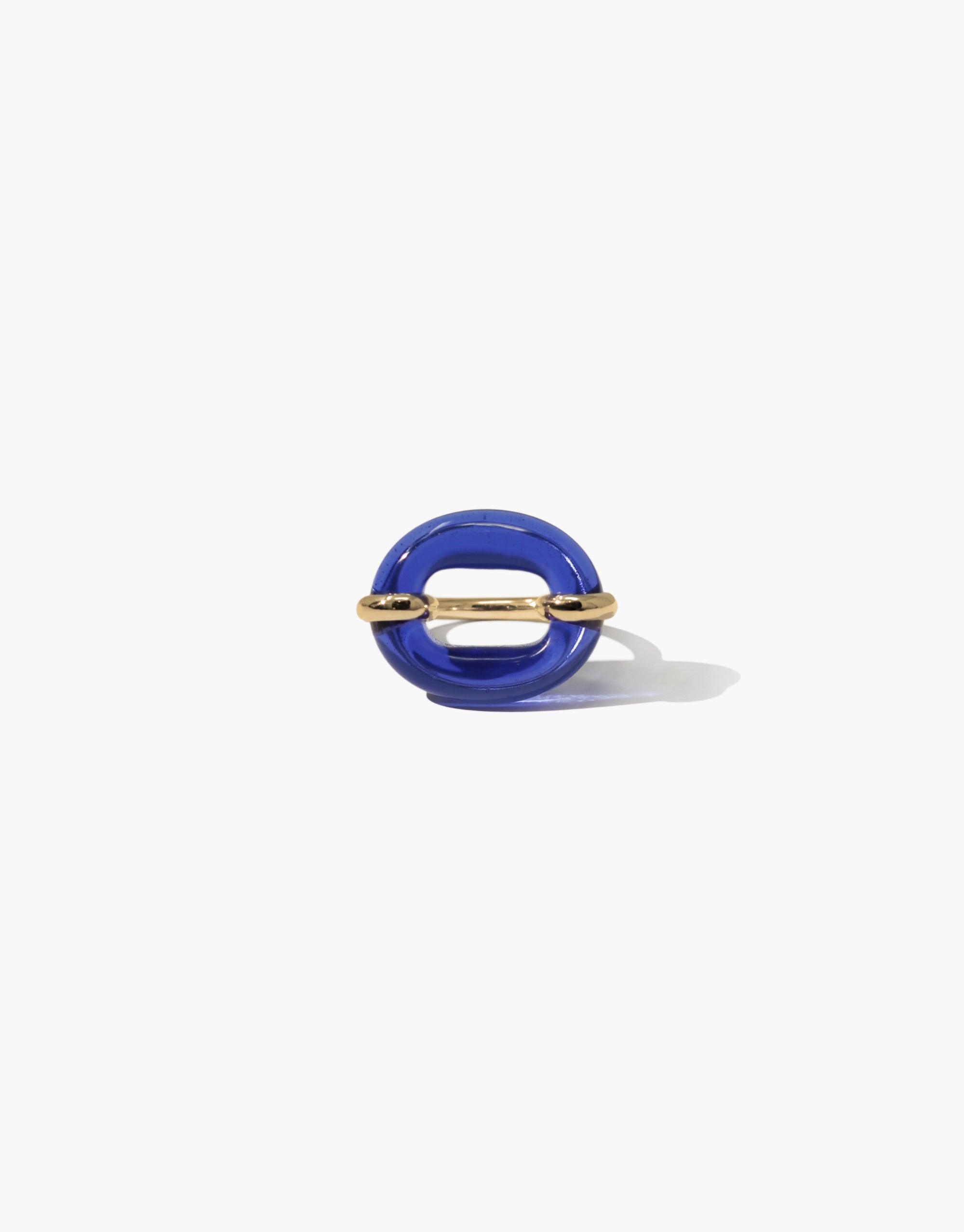 Vibrant blue glass loop with gold metallic accents, symbolizing connection and unity. Unique and sustainable In The Loop Ring, a statement piece for solidarity and style. CLED