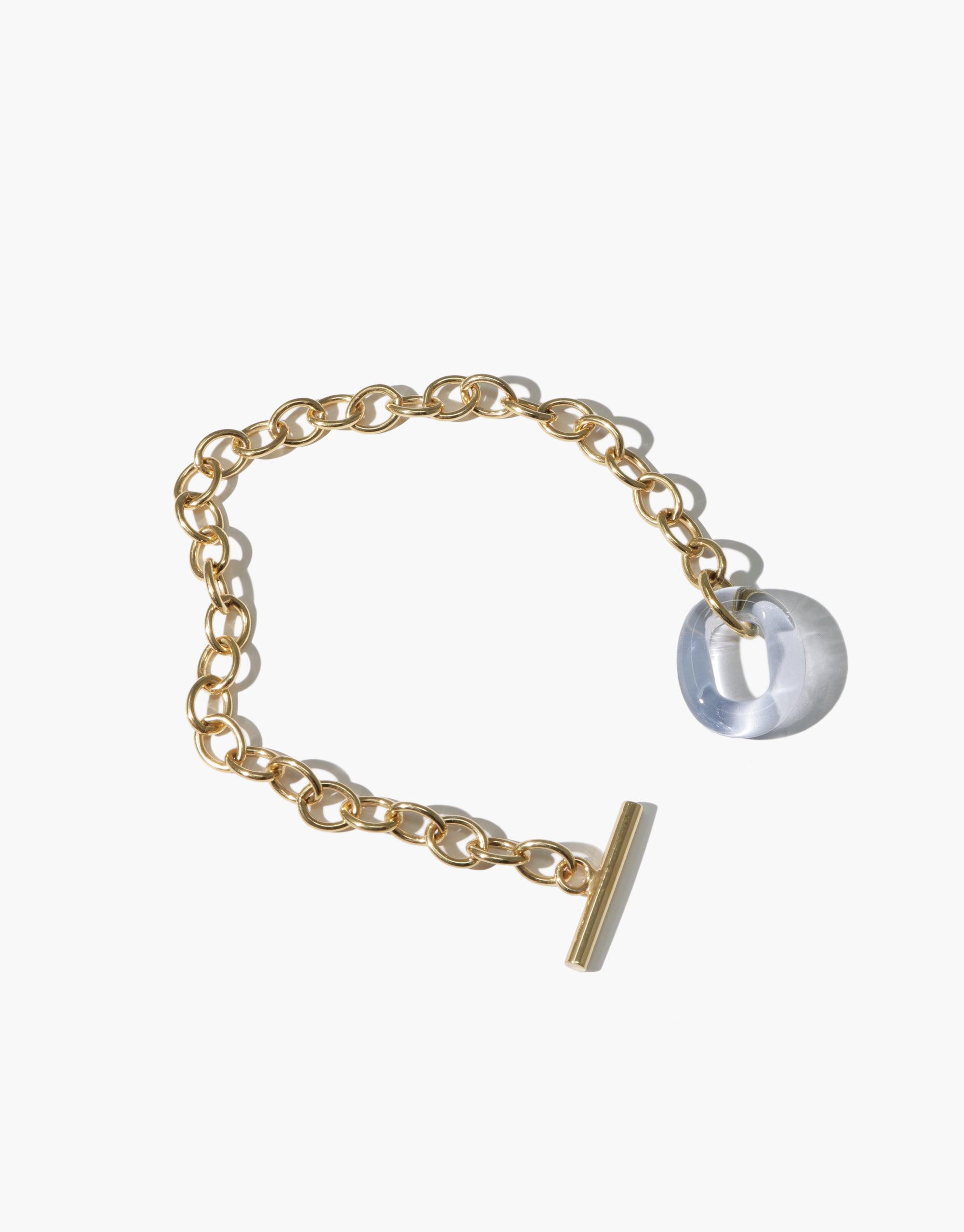 Gold-toned chain bracelet with translucent eco gem charm and toggle clasp, showcasing interlocking links and sustainable design. ITL Toggle Bracelet by CLED features adjustable length and handcrafted quality.