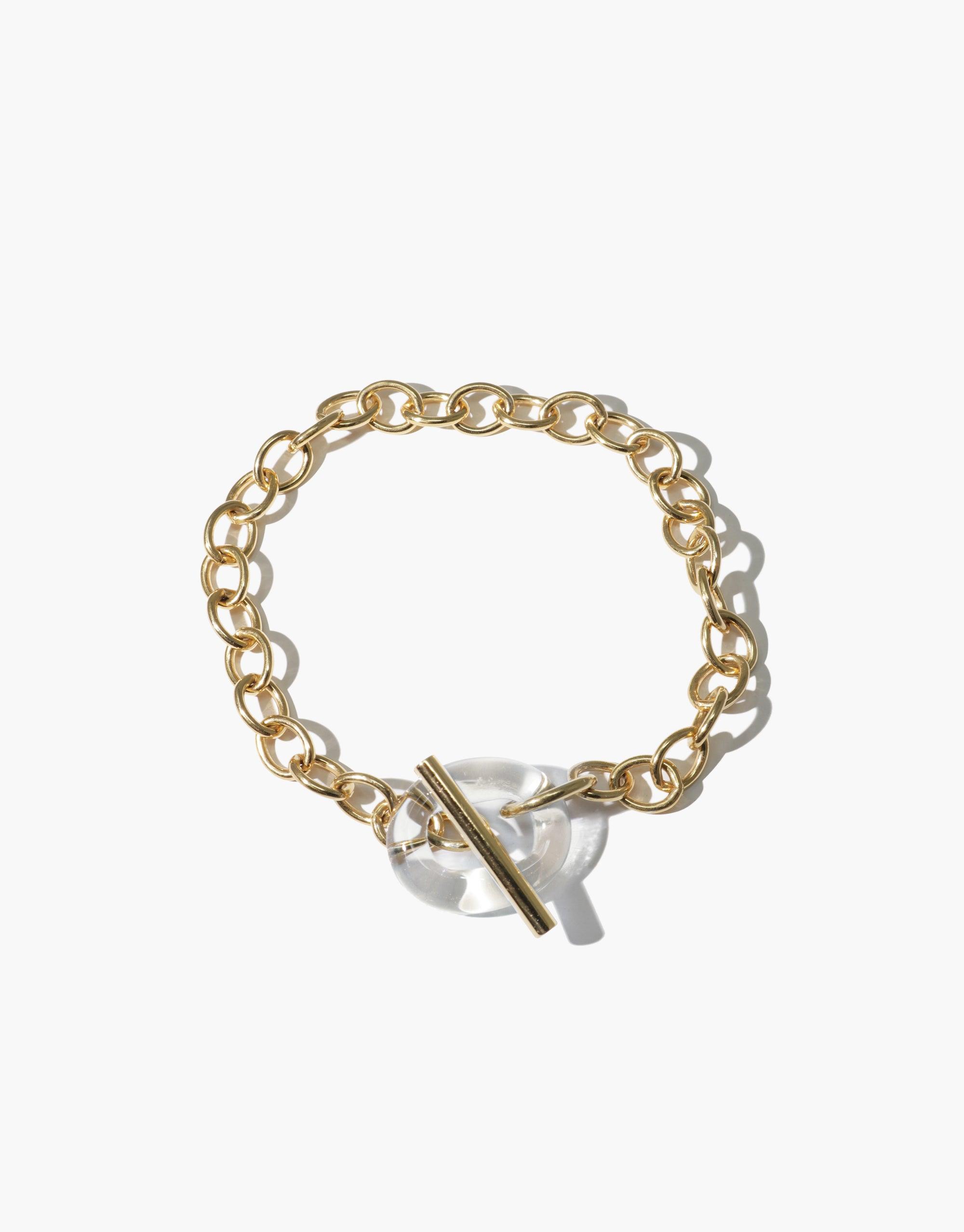 Gold-toned chain bracelet with clear eco gem toggle closure, featuring interlocking links and sustainable design. ITL Toggle Bracelet by CLED