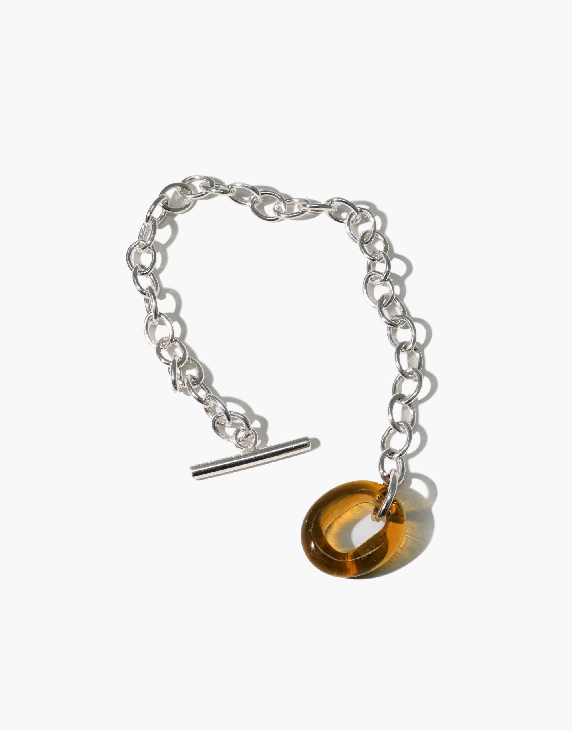 Silver chain bracelet with amber eco gem toggle closure, featuring interlocking links and adjustable length. Handcrafted ITL Toggle Bracelet by CLED, made from recycled materials.
