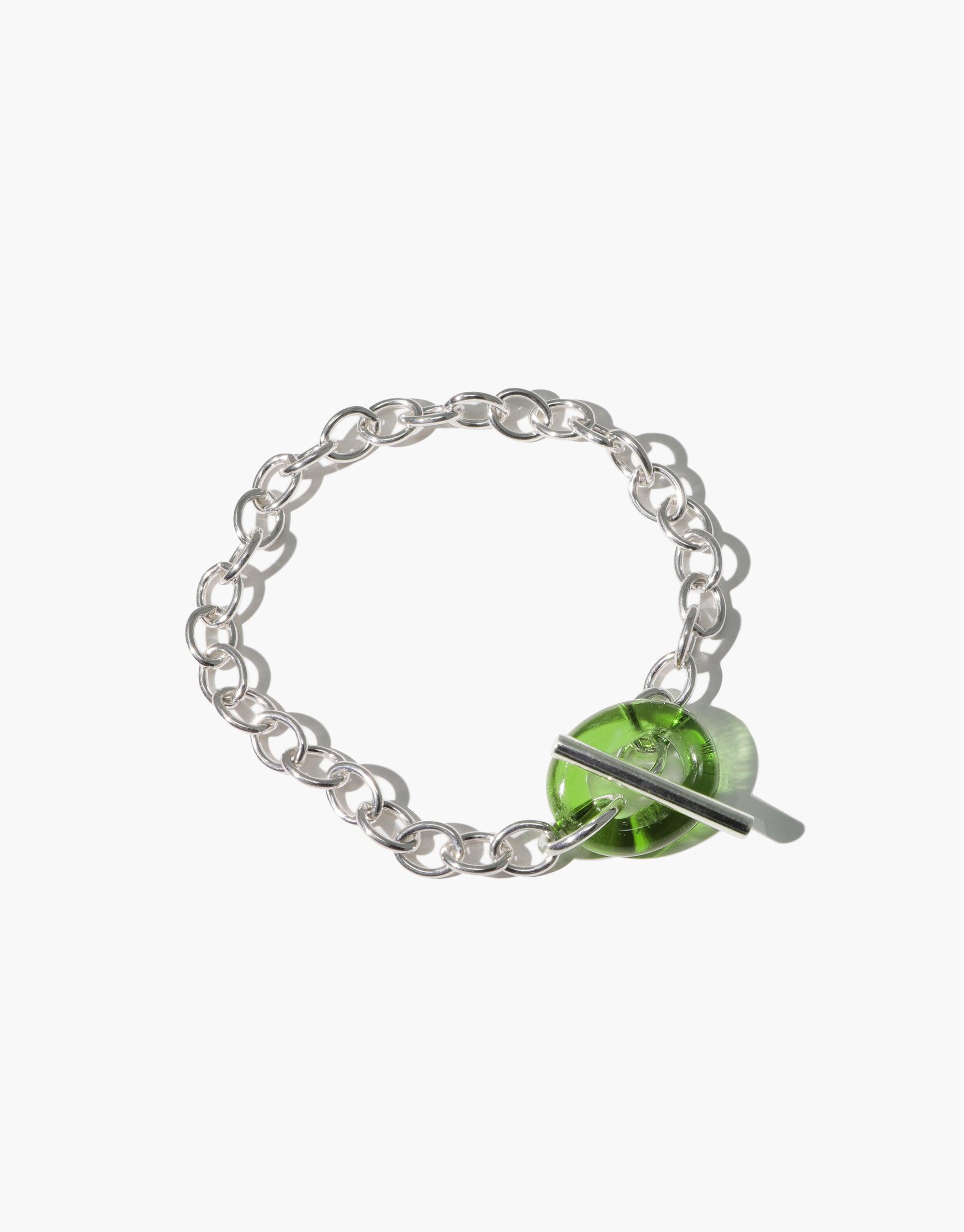 Elegant ITL Toggle Bracelet featuring interlocking silver links and a green eco gem toggle closure. Handcrafted sustainable jewelry piece with adjustable length. Perfect for eco-conscious fashion lovers. ITL Toggle Bracelet by CLED