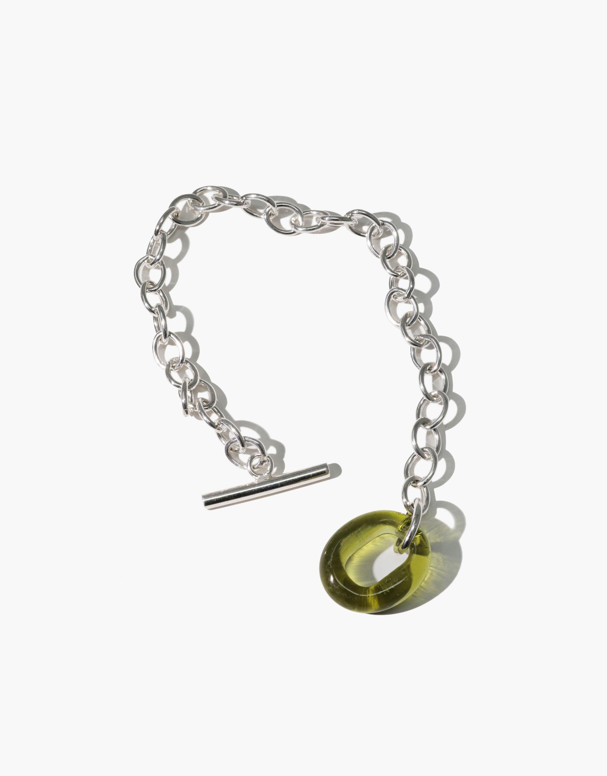 ITL Toggle Bracelet featuring lightweight interlocking silver links with a green eco gem charm. Adjustable toggle closure for versatile fit. Handcrafted sustainable jewelry by CLED.