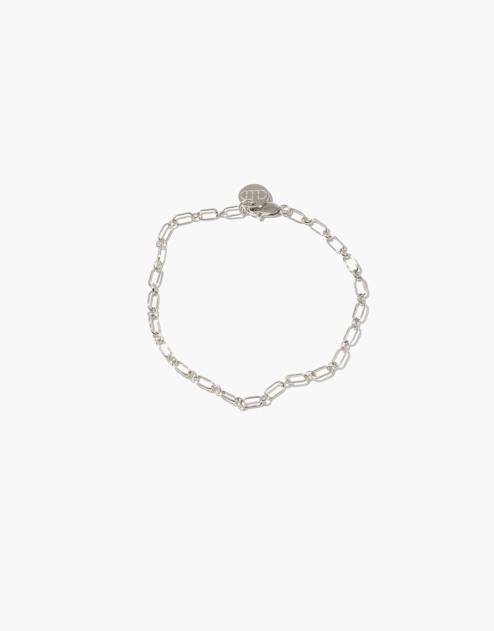 Sleek silver chain bracelet with delicate oval links and circular charm, perfect for customization with Icon charms or as a standalone statement piece. Icon Chain Bracelet | B by CLED