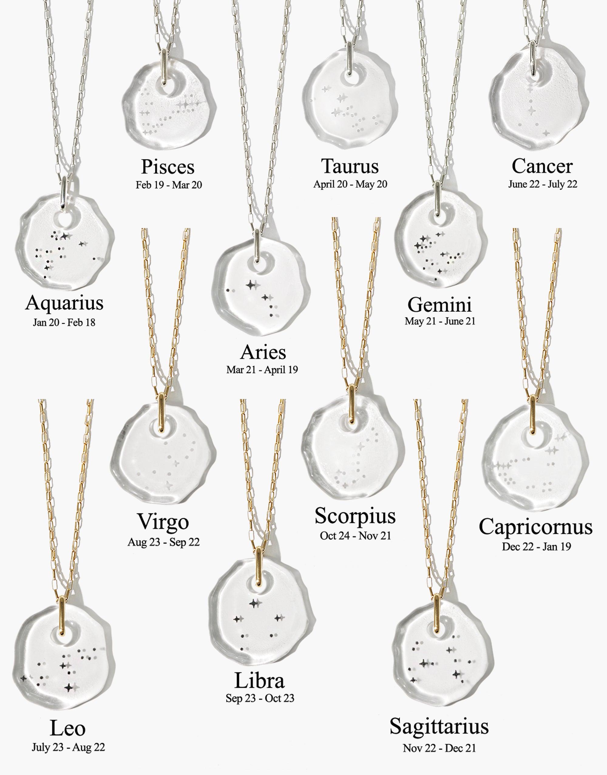 Constellation Necklace featuring 12 zodiac sign pendants with engraved star patterns on eco-friendly glass discs, suspended from delicate chains. Handcrafted, sustainable jewelry showcasing astrological designs for personalized style. CLED