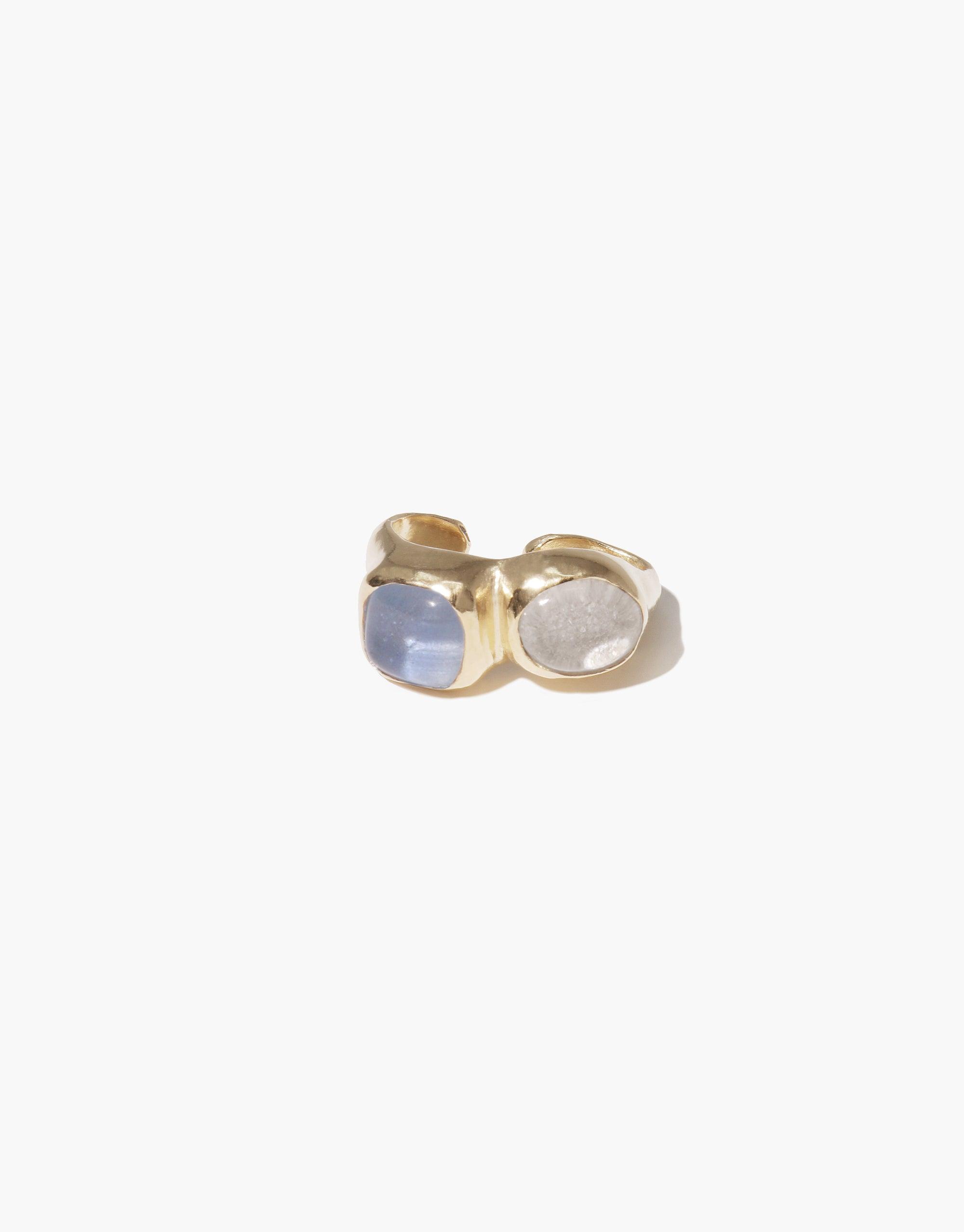 Duo Sculpture Ear Cuff featuring a gold-toned metal band with two contrasting oval stones - one pale blue and one clear - set side by side. Elegant and minimalist design, perfect for everyday wear. Handcrafted jewelry by CLED.