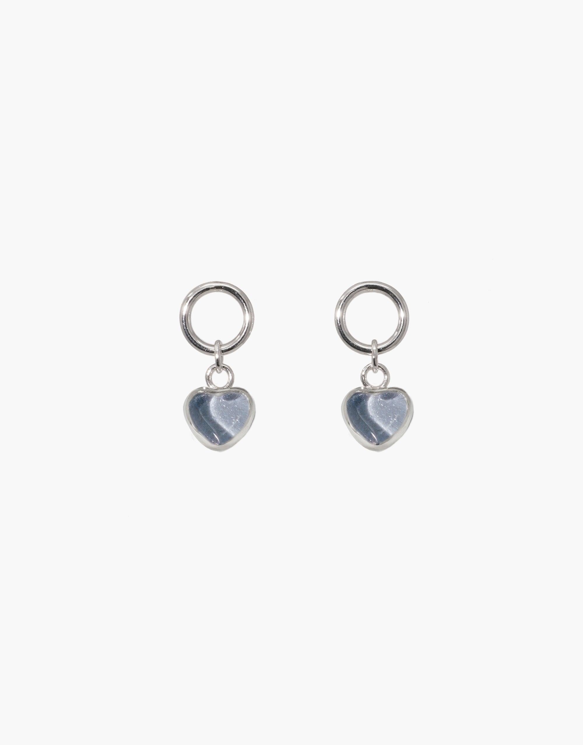 Heart Dangling Earrings featuring small silver hoops with light blue heart-shaped charms. Delicate and elegant design showcasing upcycled eco gems. Perfect for everyday wear or special occasions. Handcrafted jewelry by CLED.