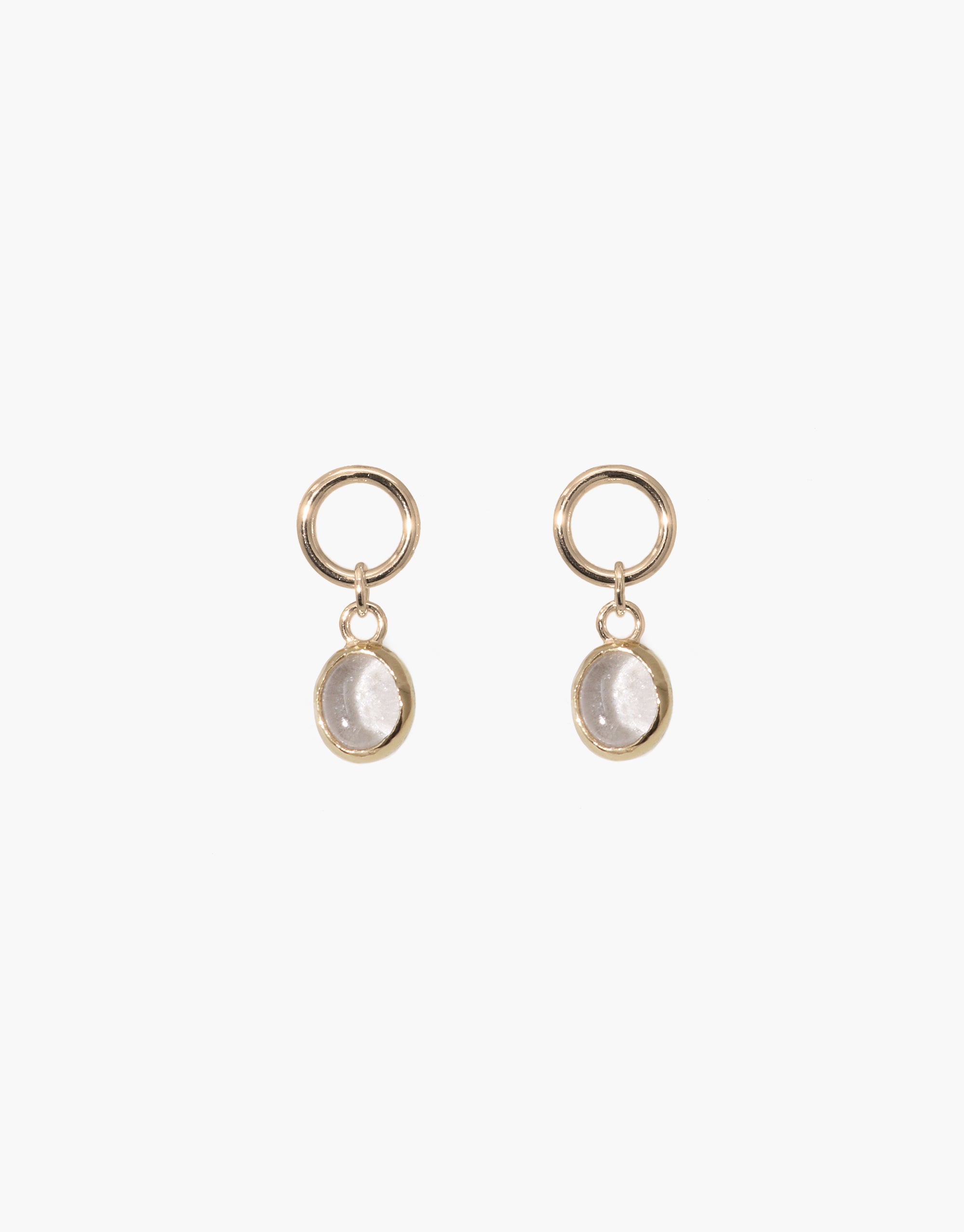 Elegant oval dangling earrings featuring gold-toned hoops and clear upcycled glass charms. Handcrafted design with eco-friendly materials. Perfect for sustainable fashion lovers. Oval Dangling Earrings by CLED.