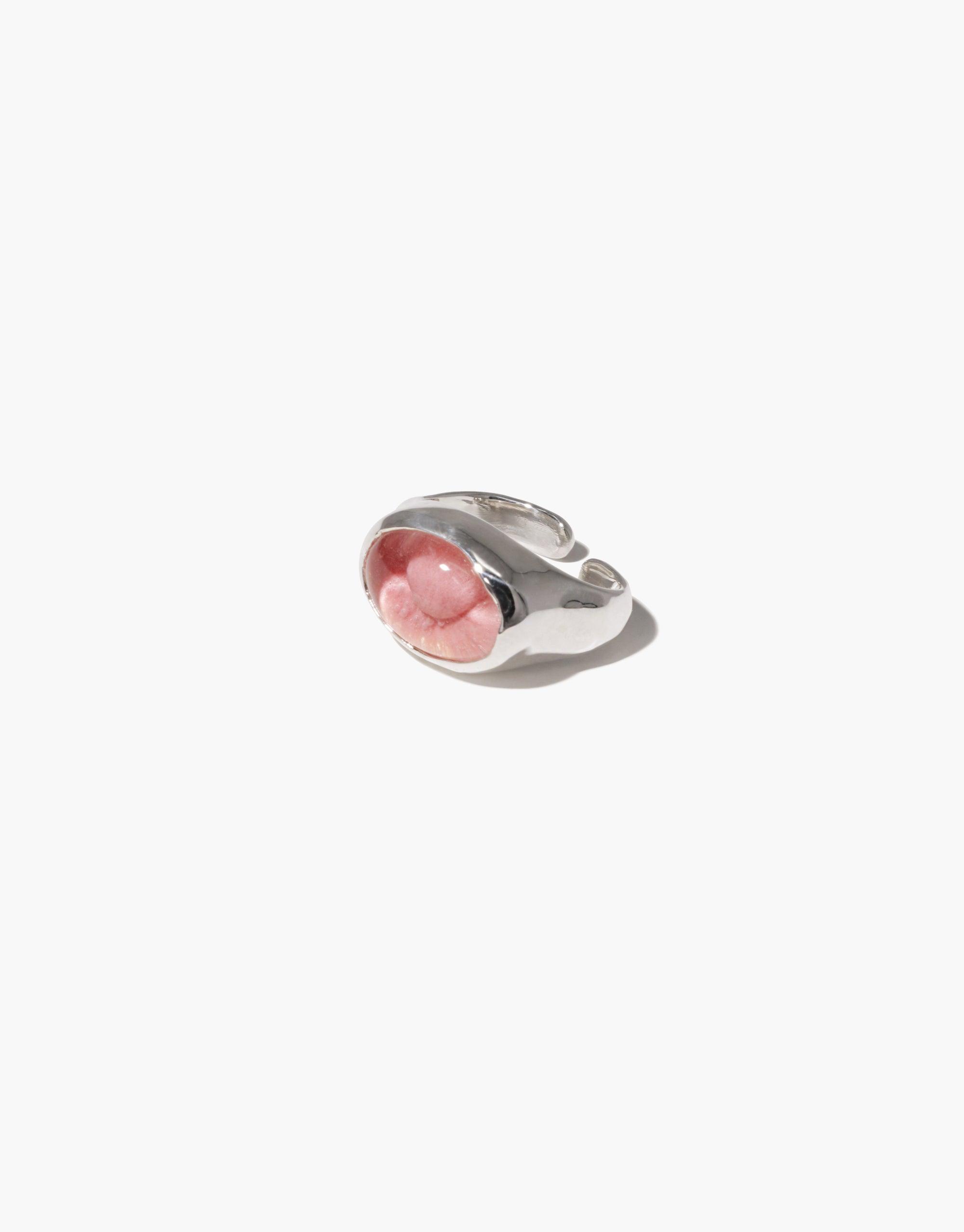 Oval Sculpture Ear Cuff featuring a sleek silver design with a pink upcycled eco gem repurposed from glass bottles. Handmade jewelry piece showcasing sustainable elegance and modern style. CLED