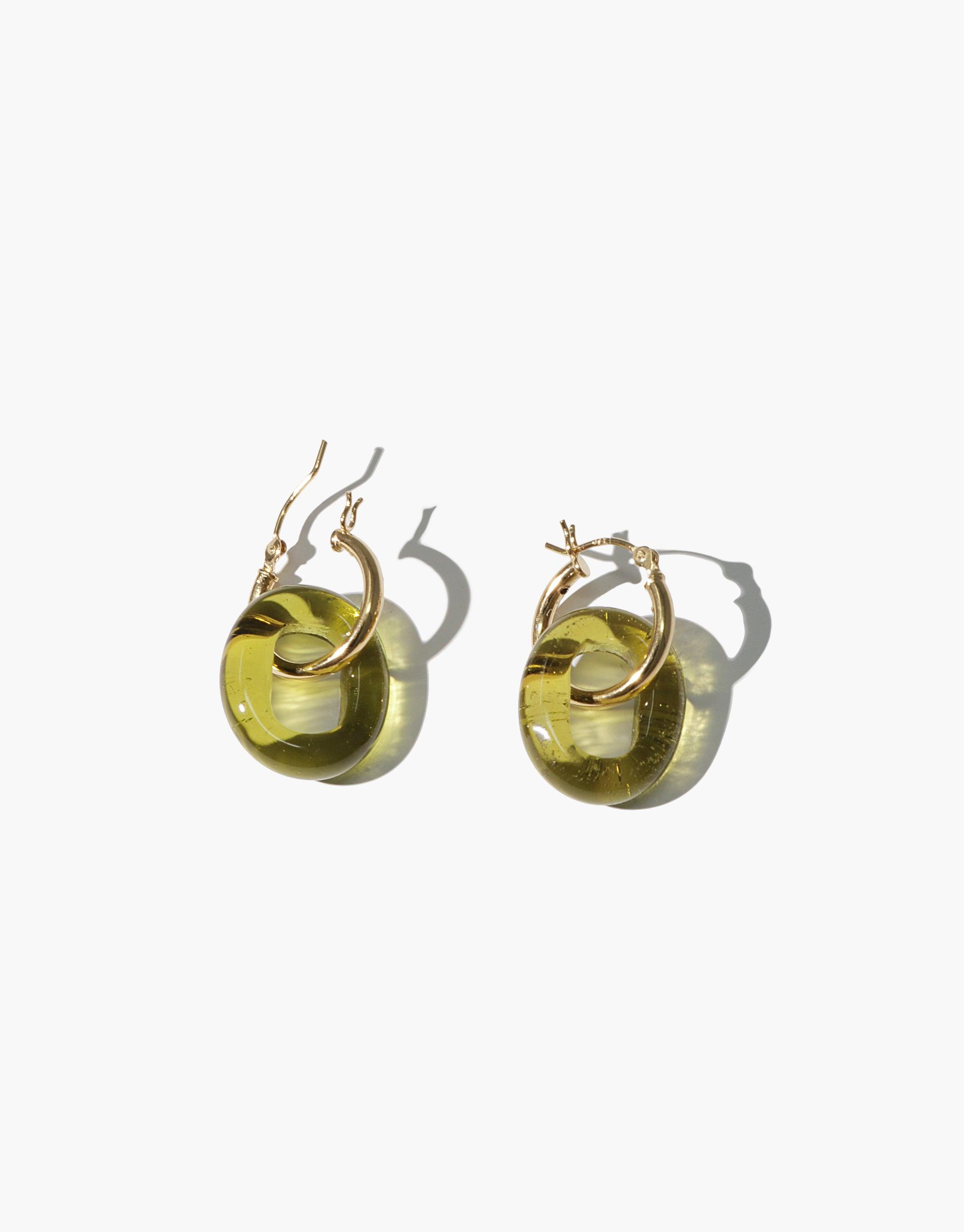 Small gold hoop earrings with translucent green eco gems made from recycled glass bottles. Minimalist design with signature loop detail. Handcrafted sustainable jewelry. In The Loop Hoops | Small by CLED