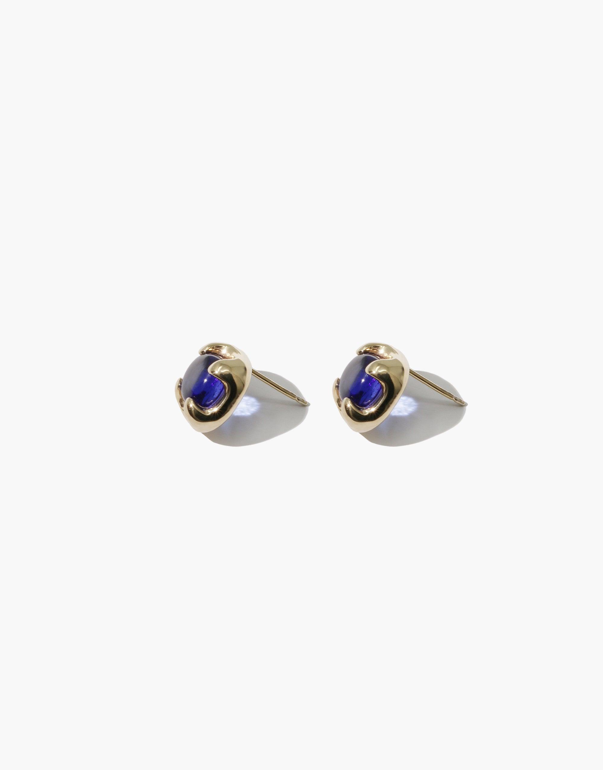Elegant Beam Earrings featuring gold-toned metal with vibrant blue eco gems, handcrafted from upcycled glass. These sustainable, minimalist studs showcase CLED's commitment to eco-friendly jewelry design. Beam Earrings by CLED.