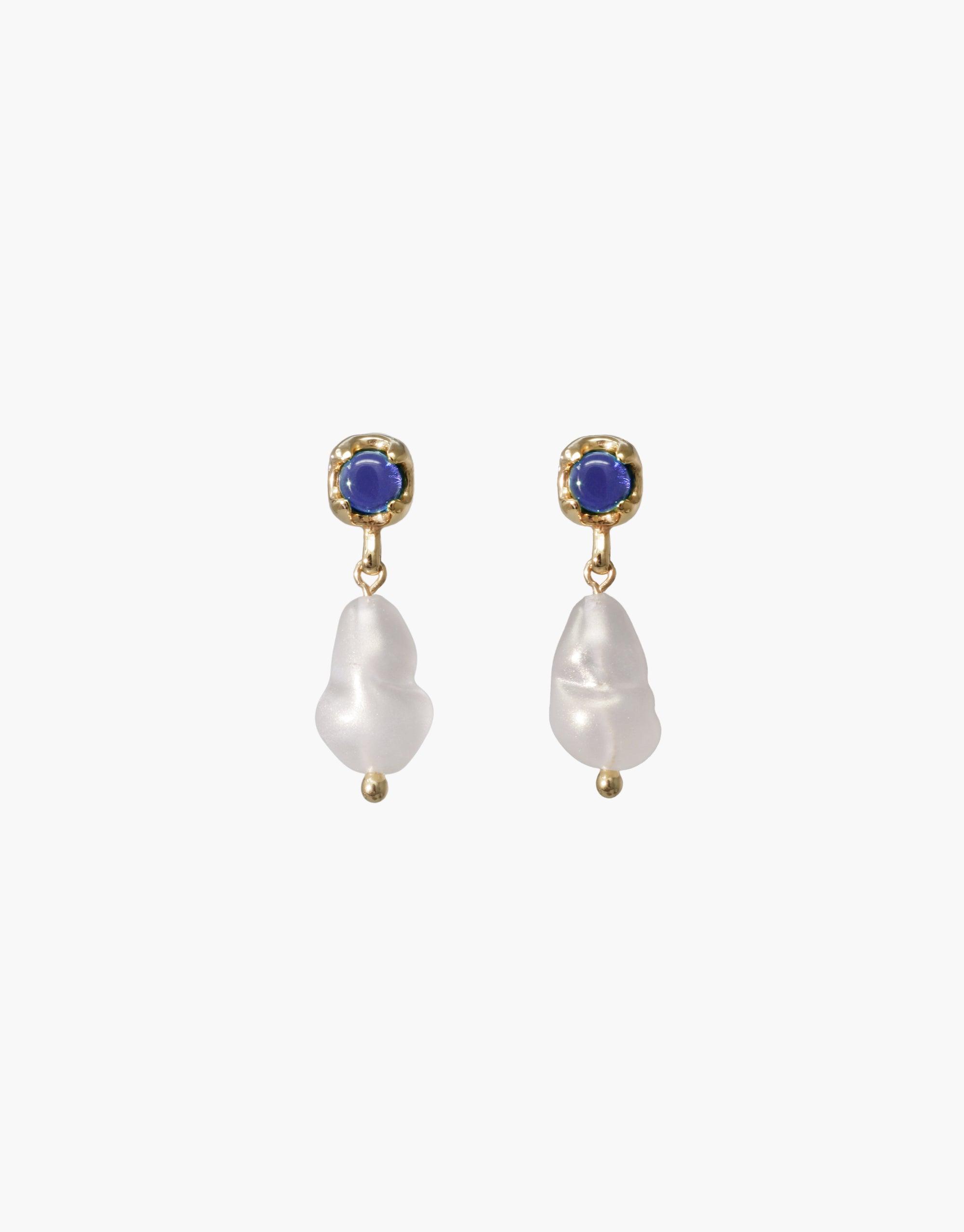 Elegant Beam Pearl Earrings featuring gold-toned studs with blue gemstones and dangling baroque pearls. Handcrafted sustainable jewelry showcasing eco-friendly materials and unique design. Perfect for adding a touch of sophistication to any outfit. CLED Beam Pearl Earrings.