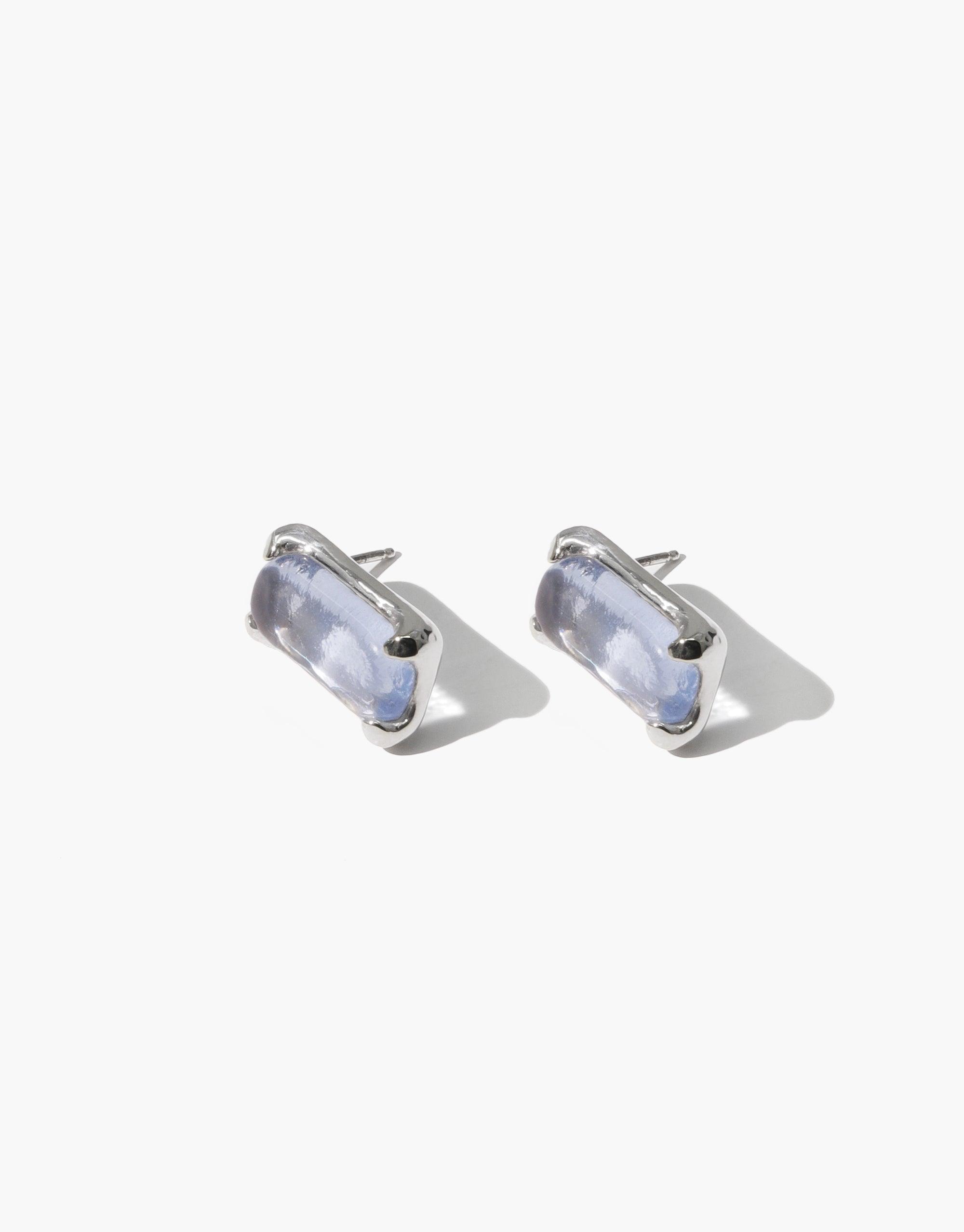 Elegant Prism Earrings featuring rectangular eco gems in light blue hues, set in silver-toned metal. Handcrafted studs with a subtle shimmer, showcasing sustainable luxury and modern design. Perfect for everyday wear or special occasions. CLED Prism Earrings.