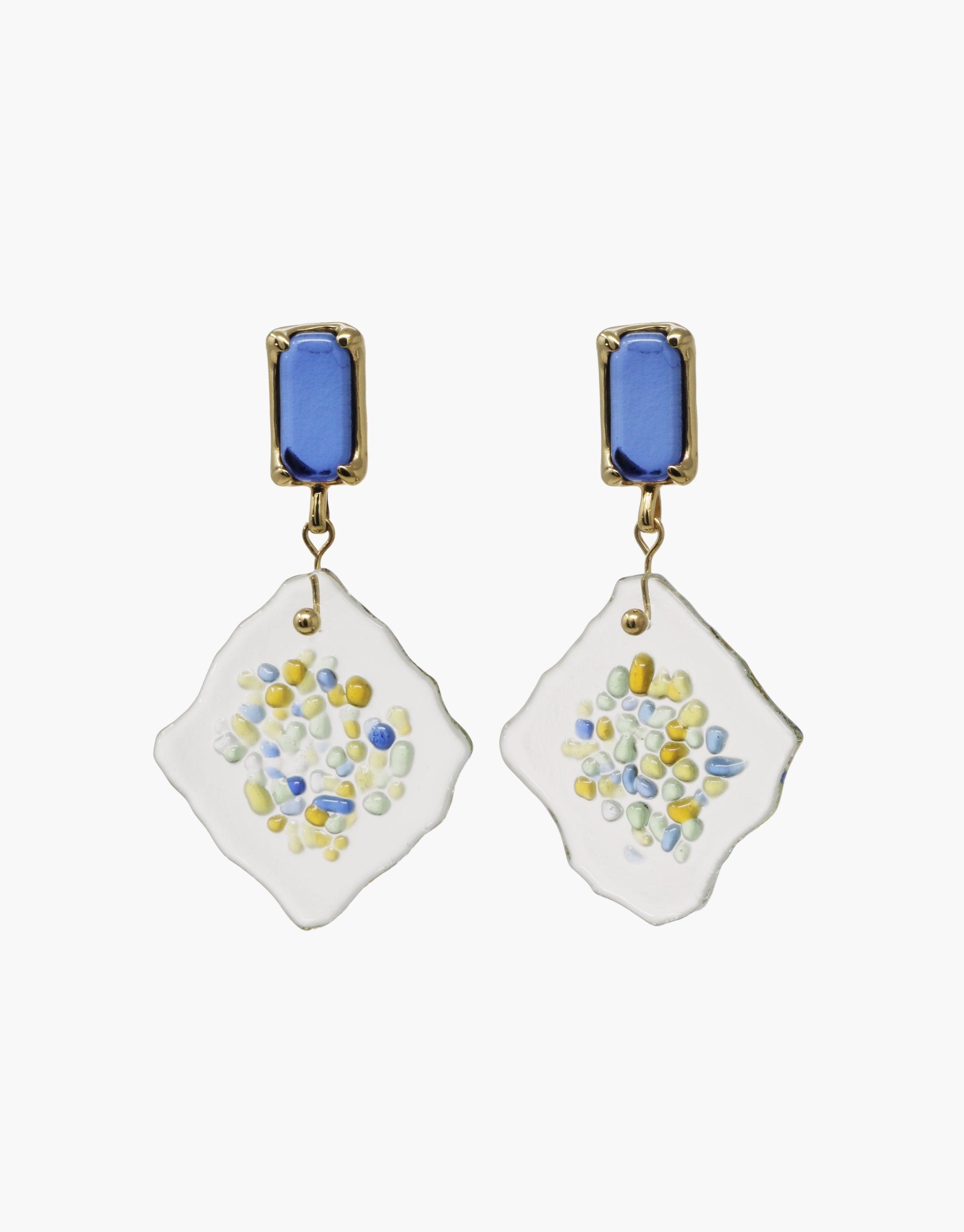 Spectral Prism Earrings featuring blue glass studs and white irregular diamond-shaped pendants with colorful speckles, showcasing eco-friendly upcycled glass design. Handcrafted sustainable jewelry representing prism light refraction. CLED