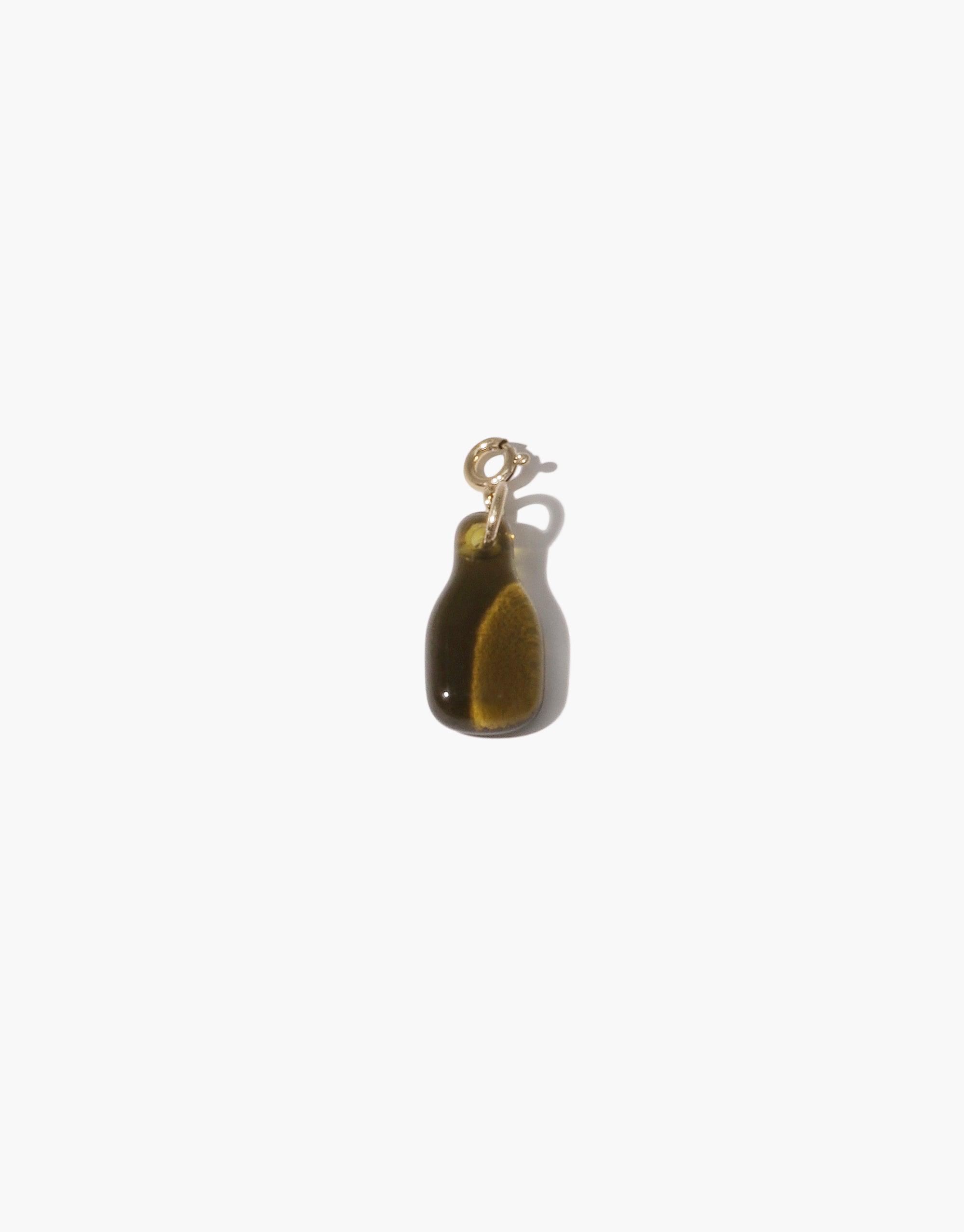 Bottle Icon Charm featuring a miniature upcycled glass bottle pendant in dark amber color with gold-toned metal loop, showcasing eco-friendly craftsmanship and versatile design for necklaces or bracelets. Handmade sustainable jewelry accessory by CLED. Bottle | Icon Charm