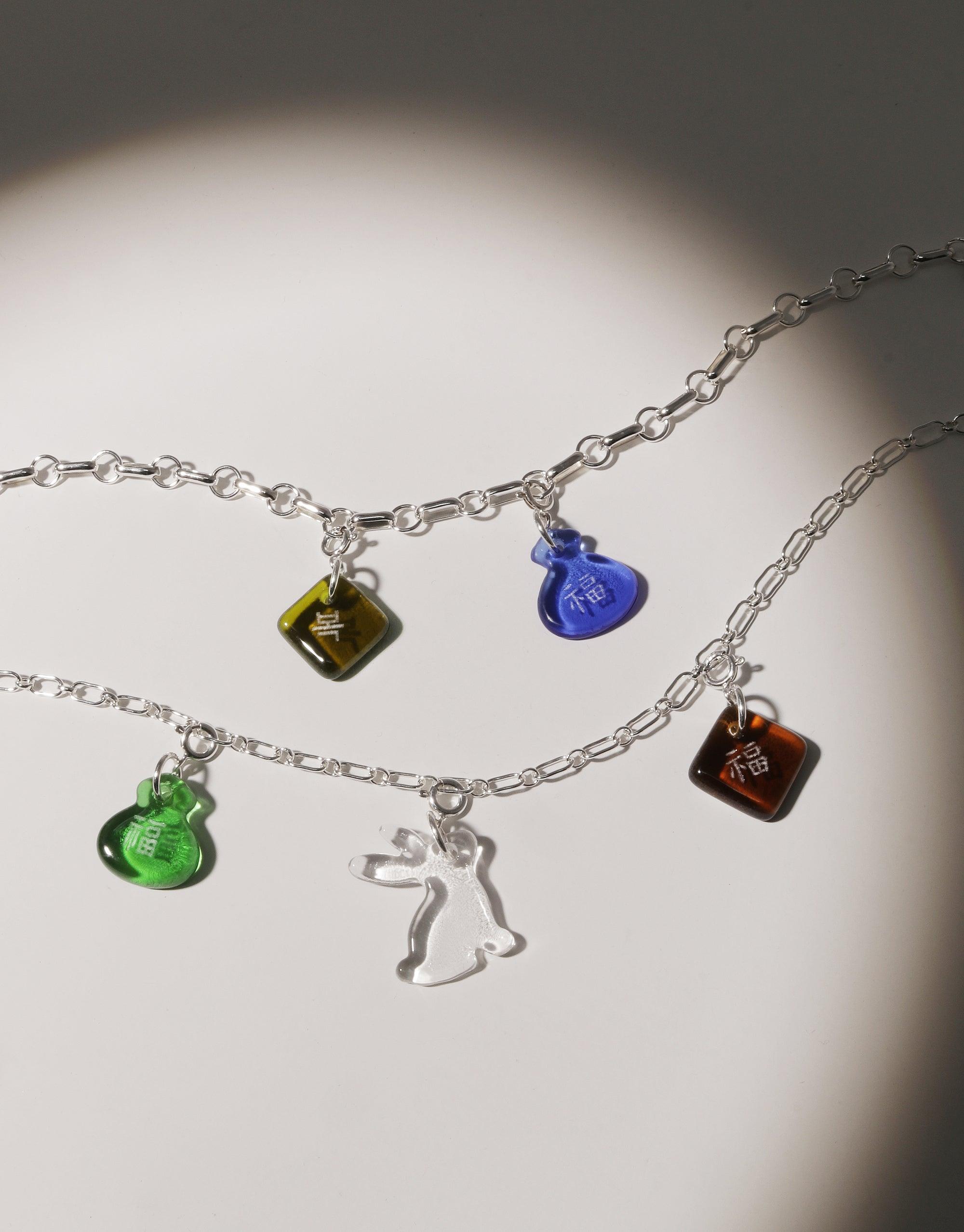 Silver chain necklace with colorful glass charms including a clear rabbit charm, celebrating Lunar New Year. Handcrafted eco-friendly jewelry featuring Rabbit Icon Charm. Sustainable and stylish accessories by CLED.