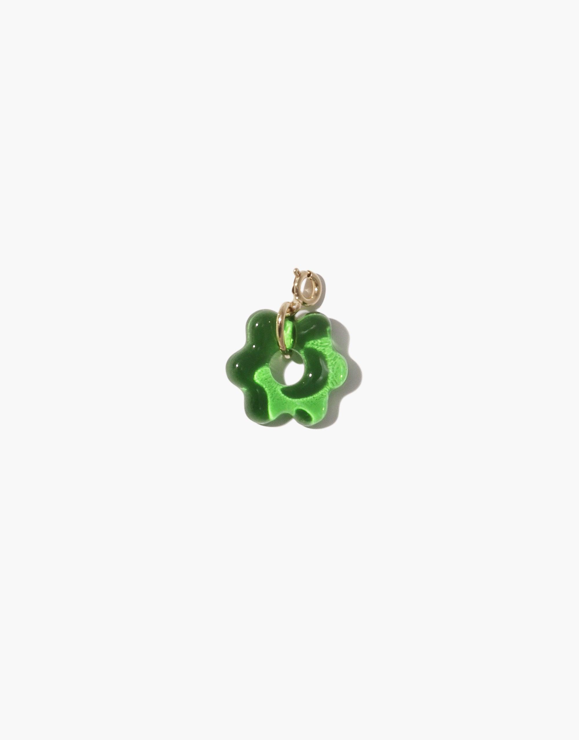 Green flower-shaped charm made from upcycled glass, featuring a gold-toned metal loop for attachment. Avens Icon Charm showcases sustainable jewelry design with its unique eco-friendly aesthetic. CLED