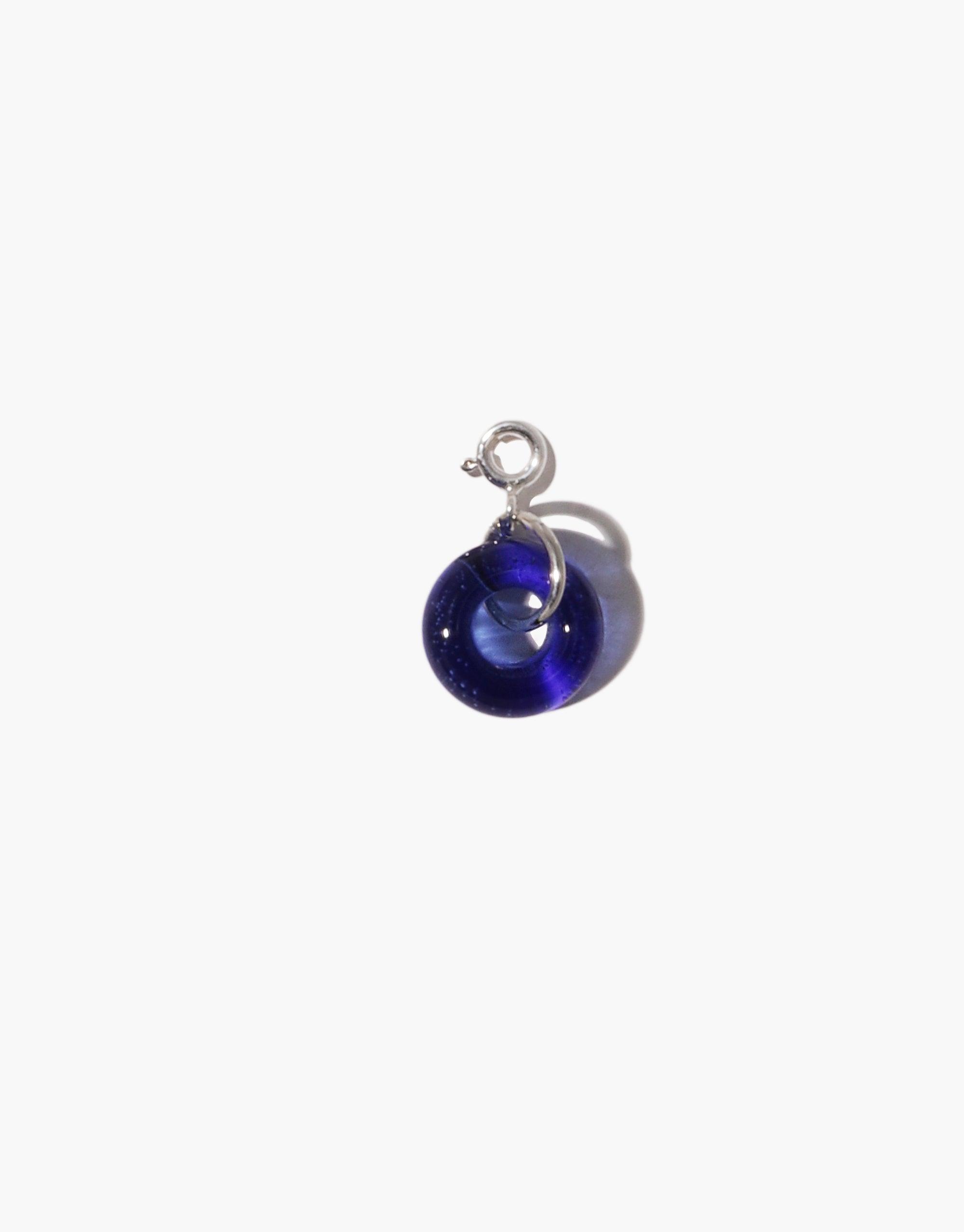 Handcrafted Donut Icon Charm featuring a deep blue upcycled glass sphere with silver hook, perfect for personalizing necklaces or bracelets. Sustainable jewelry piece from CLED's Icon Charm collection.