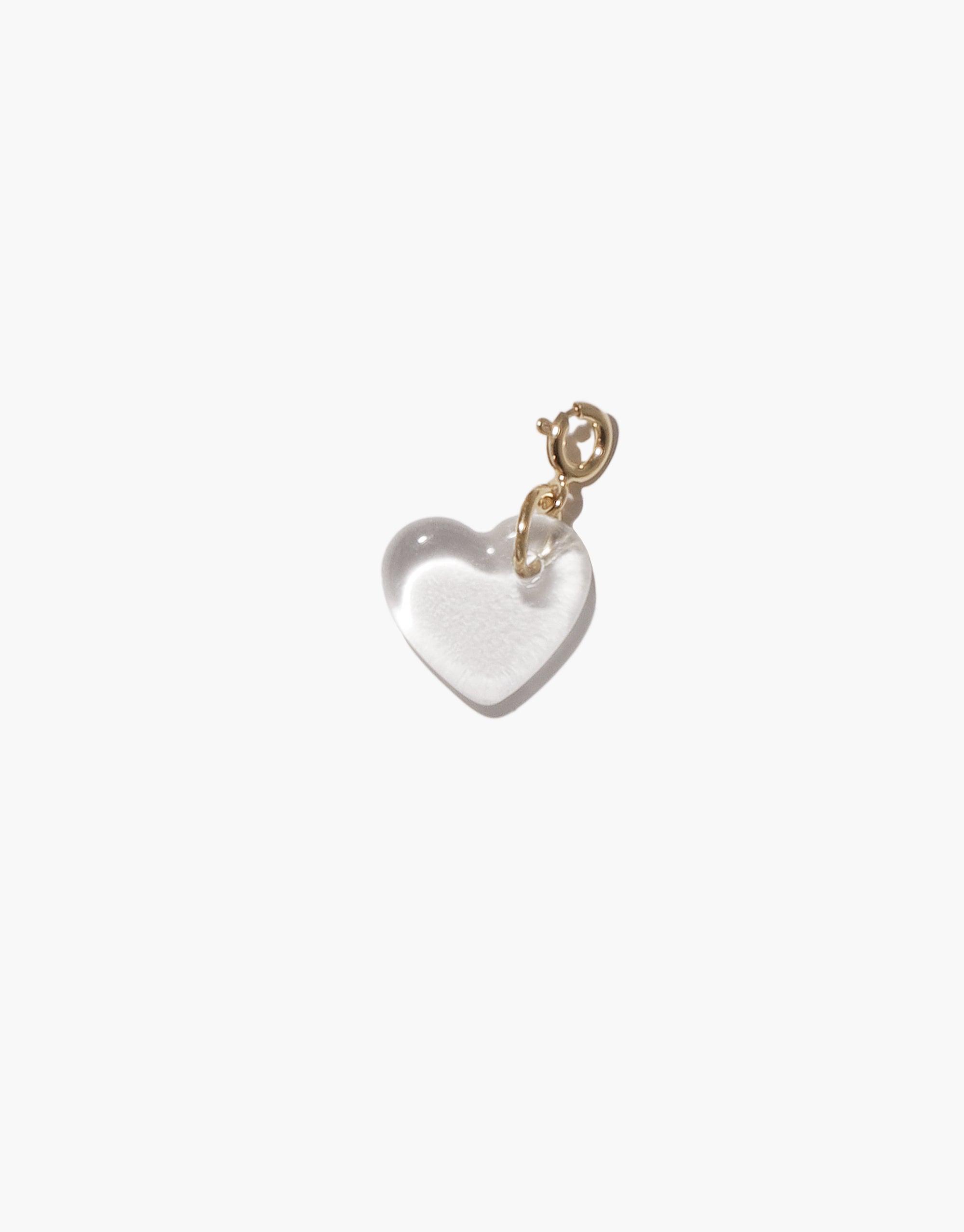 Heart-shaped glass charm with gold-toned metal clasp, showcasing a translucent white appearance. Handcrafted icon charm for necklaces or bracelets, part of the Heart | Icon Charm collection. Sustainable jewelry piece made from upcycled glass bottles by CLED.