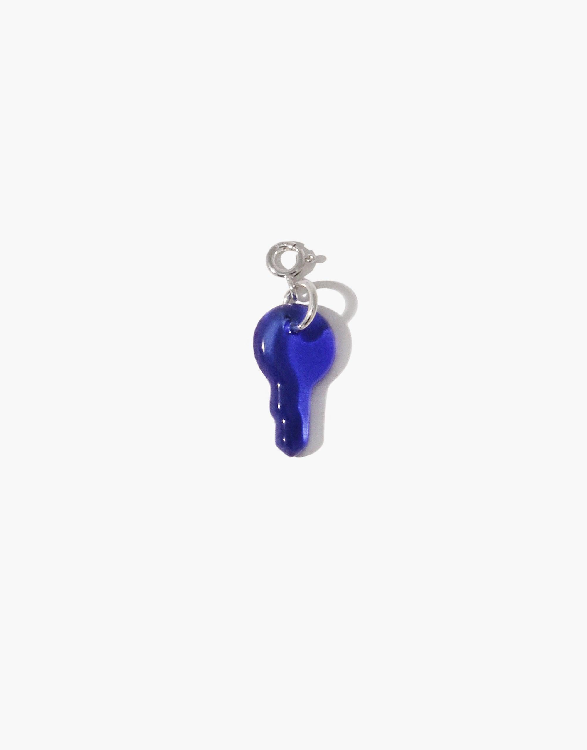 Key-shaped charm in vibrant blue glass, attached to a silver clasp. Handcrafted Icon Charm for necklaces or bracelets. Sustainable jewelry piece made from upcycled glass. Key | Icon Charm by CLED.