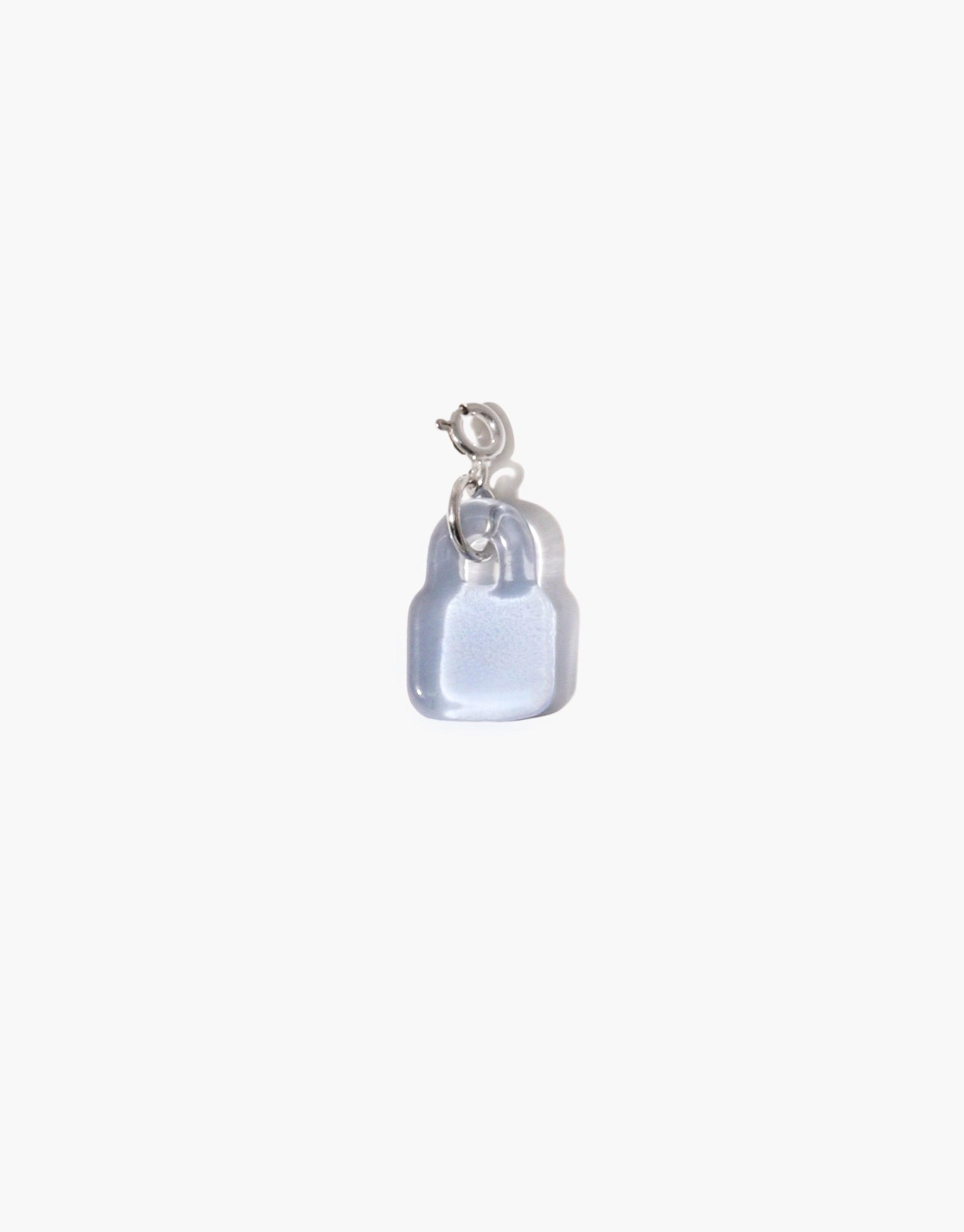 Lock Icon Charm featuring a translucent light blue padlock-shaped pendant with silver metallic clasp, showcasing handcrafted eco-friendly design. Perfect for adding personal style to necklaces or bracelets. Unique jewelry piece by CLED.