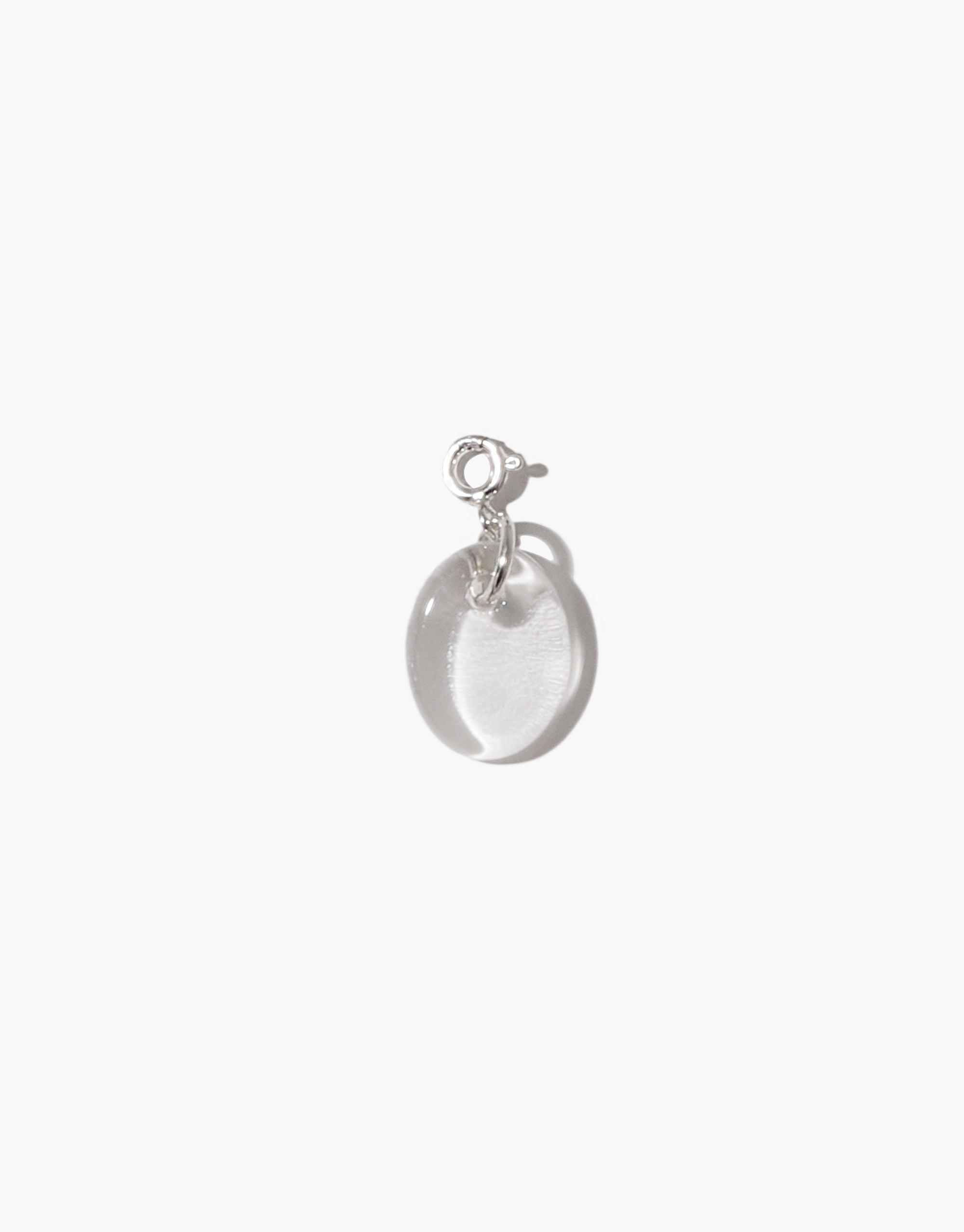 Oval Icon Charm featuring a translucent, smooth oval-shaped pendant made from upcycled glass, attached to a sterling silver clasp. Elegant and minimalist design, perfect for customizing necklaces or bracelets. Handcrafted eco-friendly jewelry by CLED.