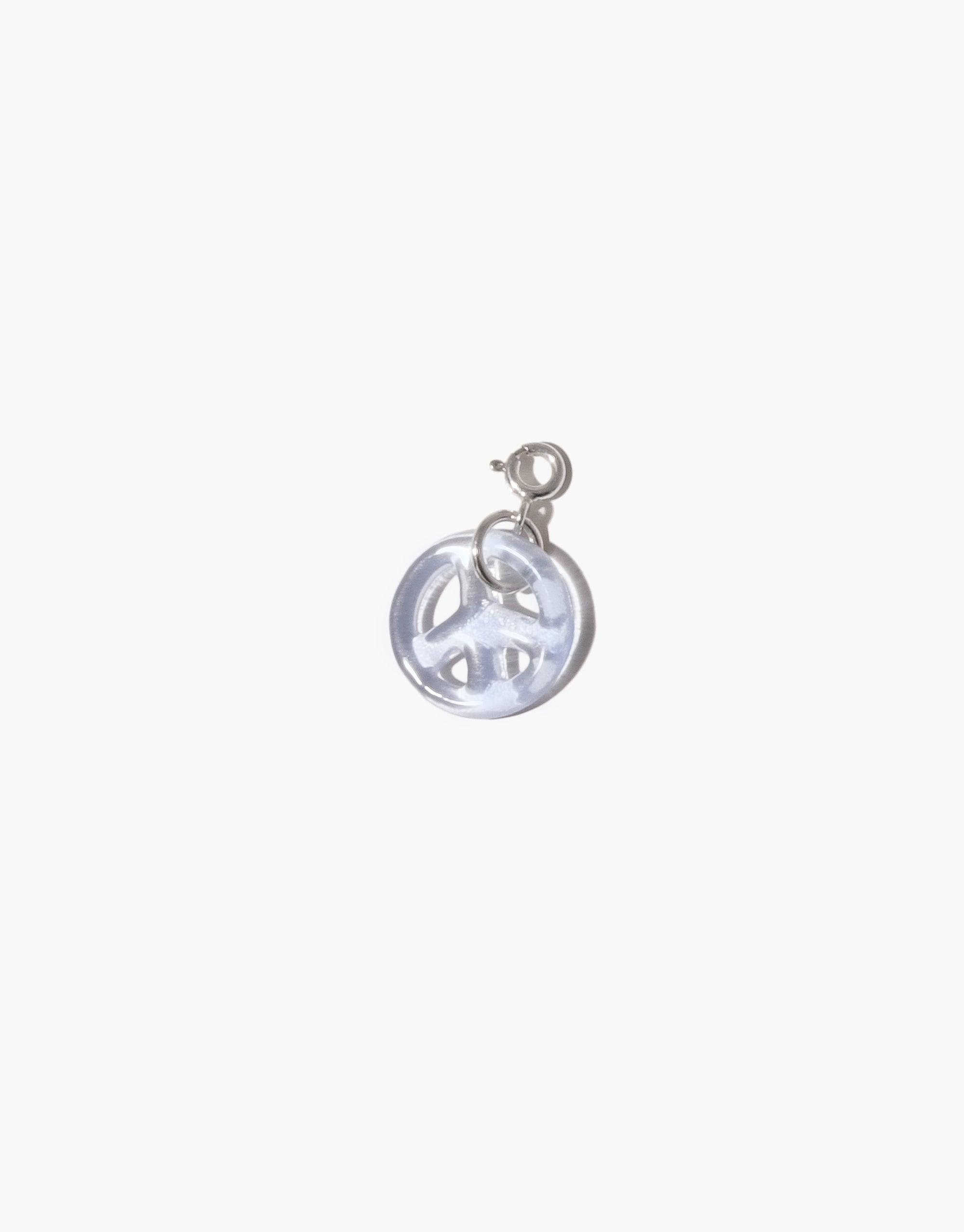 Handcrafted Peace Icon Charm in transparent glass with silver attachment, featuring a peace symbol design. Eco-friendly upcycled charm for necklaces or bracelets. Peace | Icon Charm by CLED