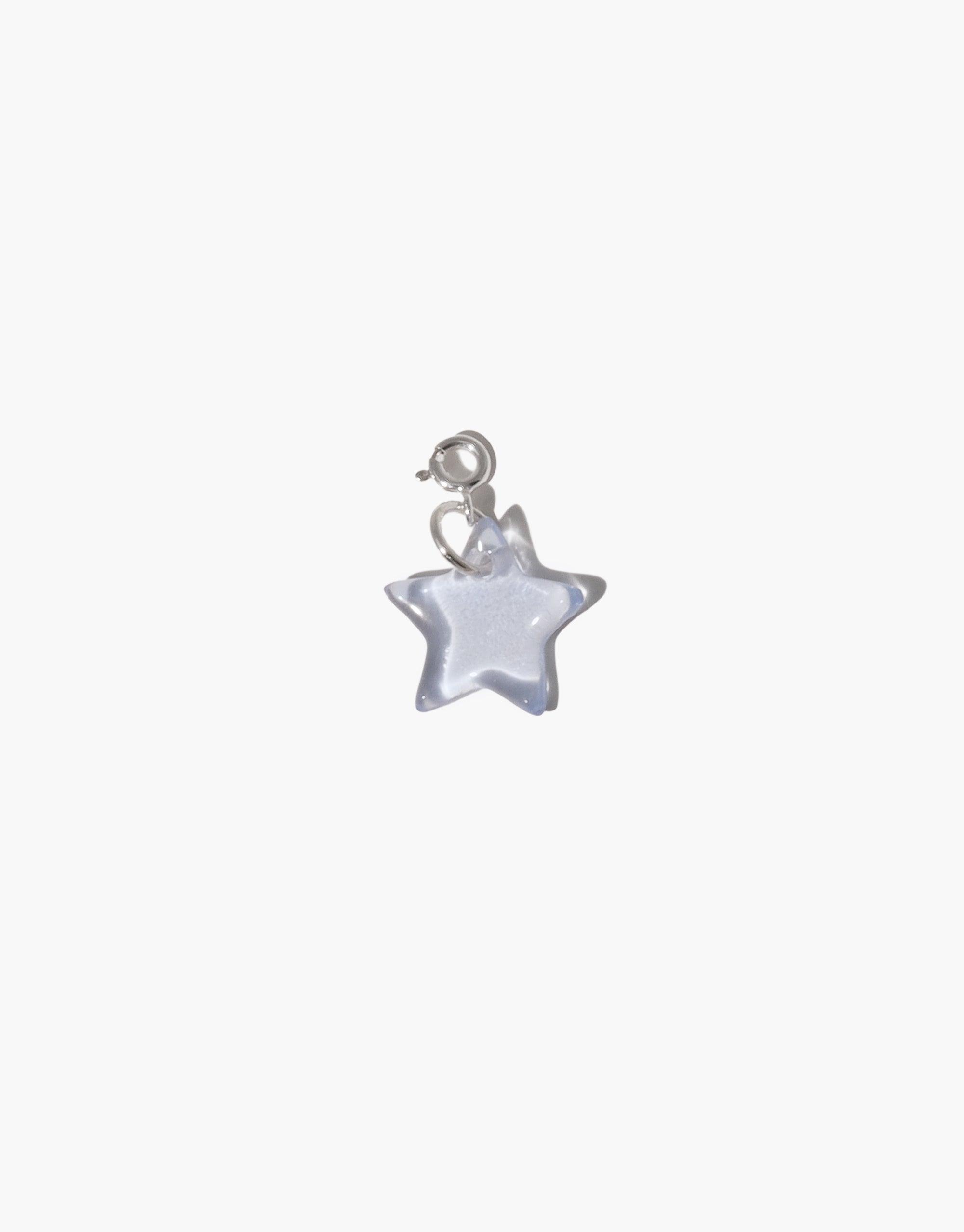 Star | Icon Charm: A close-up of a sterling silver star-shaped charm, part of CLED's eco-conscious jewelry collection, crafted from upcycled glass, designed for necklaces or bracelets.