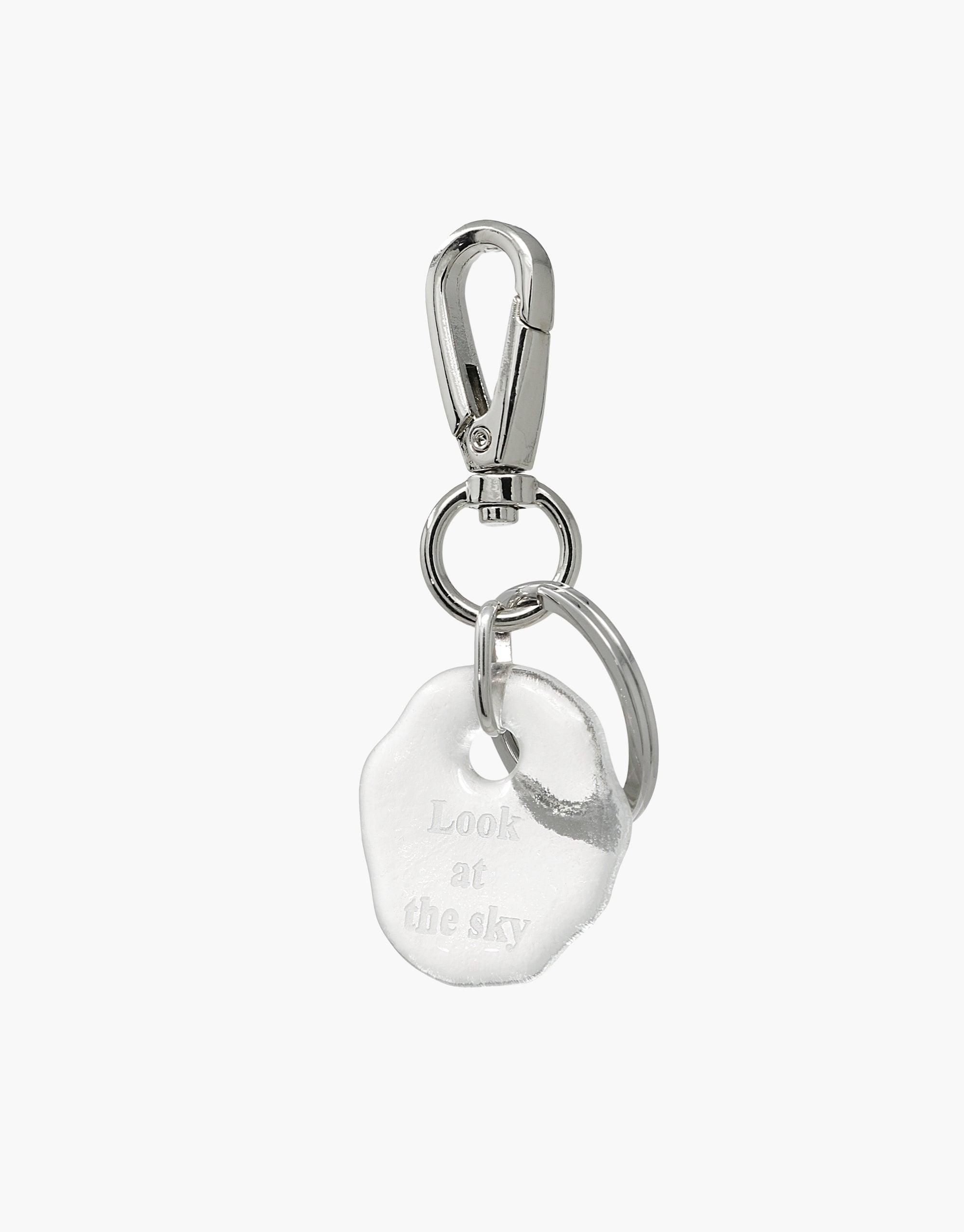 Messenger Keyring with clear glass charm engraved 'Look at the sky' attached to silver metal clasp and ring. Eco-friendly accessory made from repurposed glass. Handcrafted piece from the Messenger Collection. CLED Messenger Keyring | Look at the sky