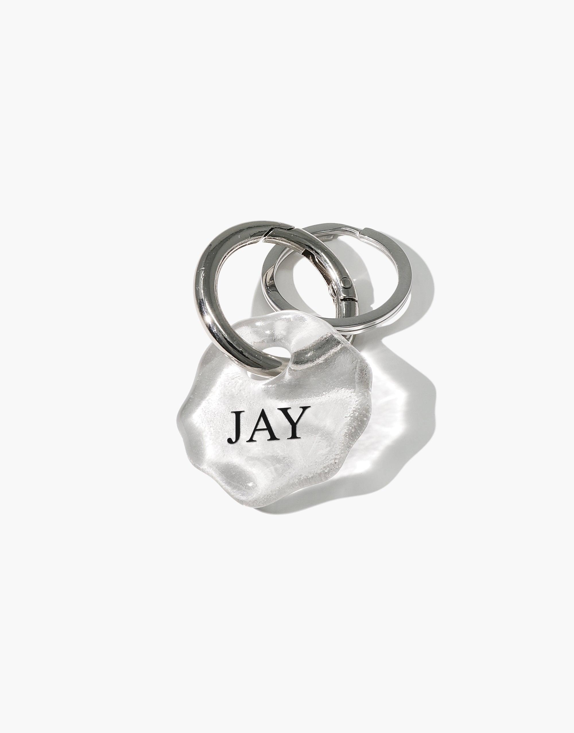 Personalized Messenger Keyring with clear Eco Gem charm engraved 'JAY', attached to stainless steel ring. Handcrafted sustainable accessory for carrying messages and connecting with loved ones. Messenger Keyring | Personalized by CLED
