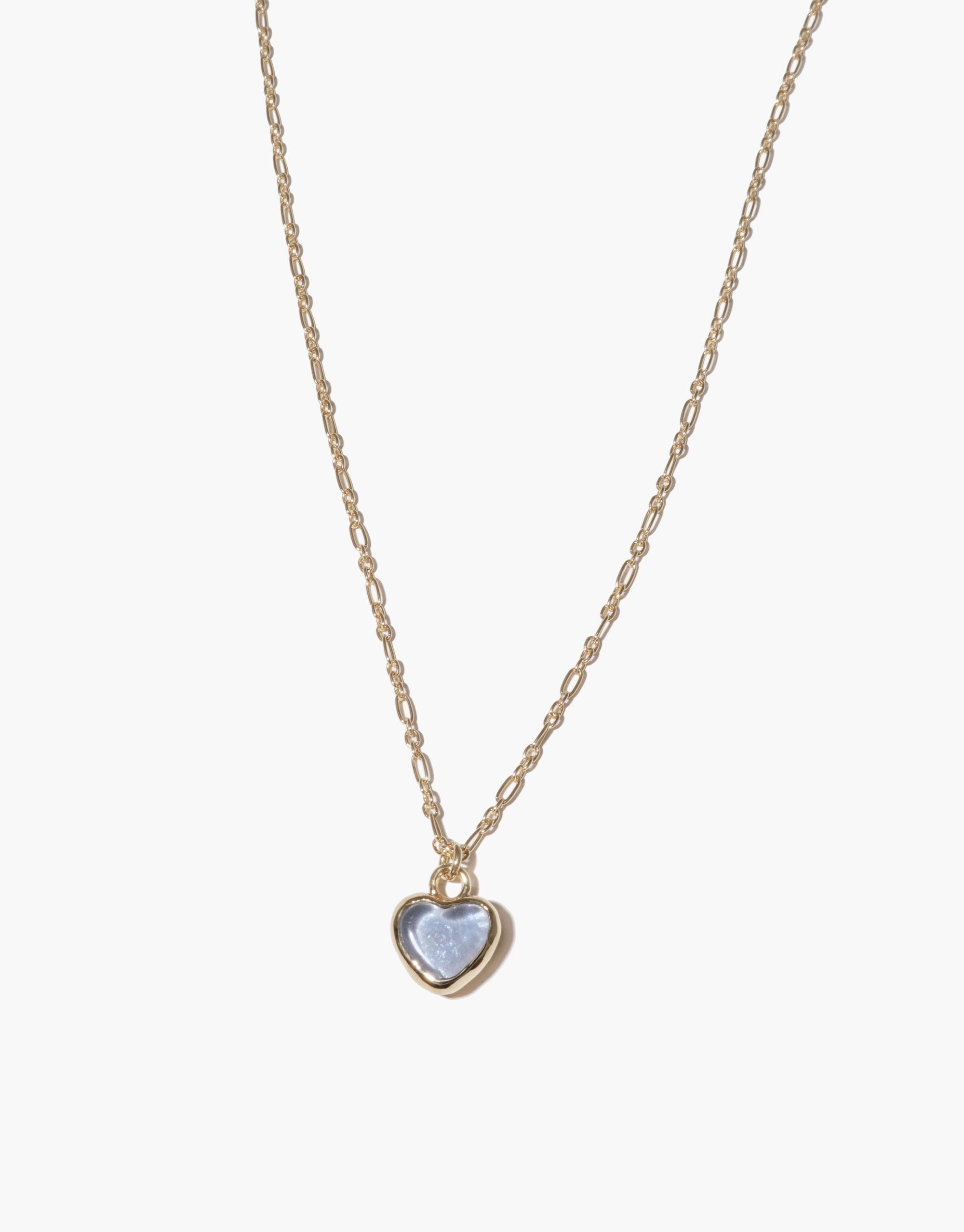 Delicate gold chain necklace with small heart-shaped charm pendant featuring light blue upcycled glass, handcrafted eco-friendly jewelry piece. Heart Charm Necklace by CLED.