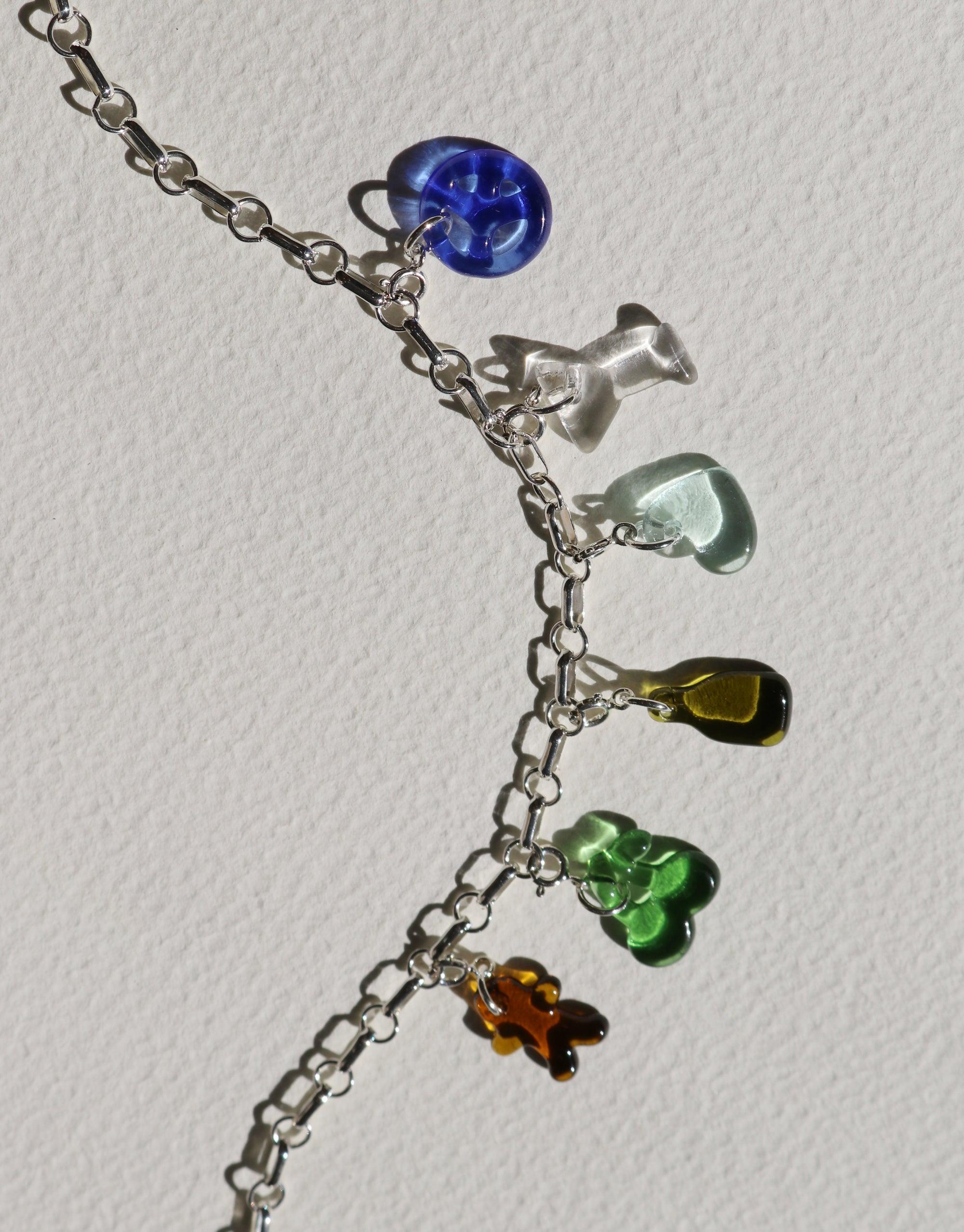 Silver charm bracelet with colorful glass icons including blue, clear, green, yellow, and orange shapes. Handcrafted jewelry featuring upcycled eco-friendly materials. Ginger Man | Icon Charm by CLED