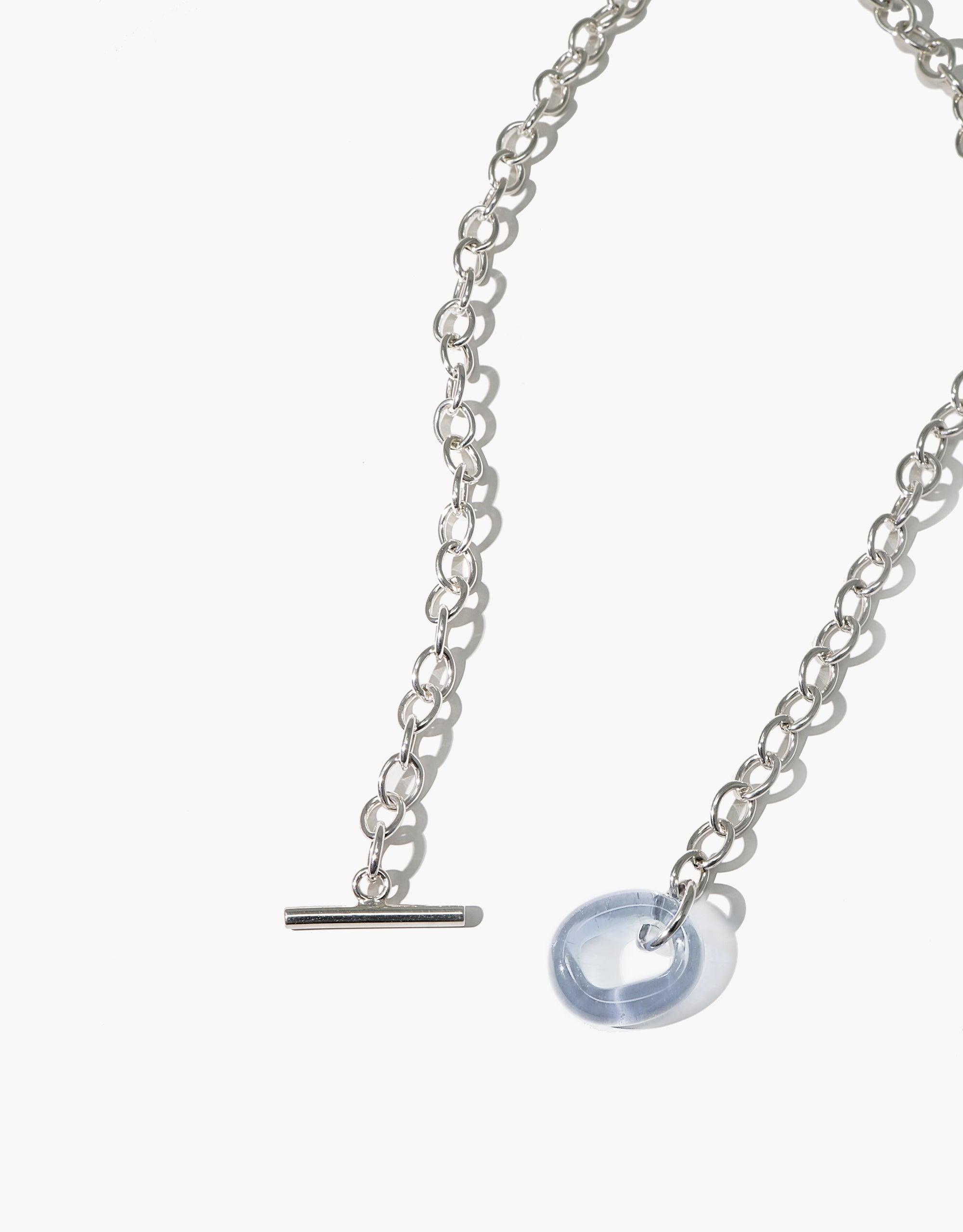 Elegant ITL Toggle Choker Necklace featuring delicate silver chain with interlocking links and a light blue eco gem pendant. Stylish accessory for a sustainable fashion statement. Handcrafted in Los Angeles by CLED.