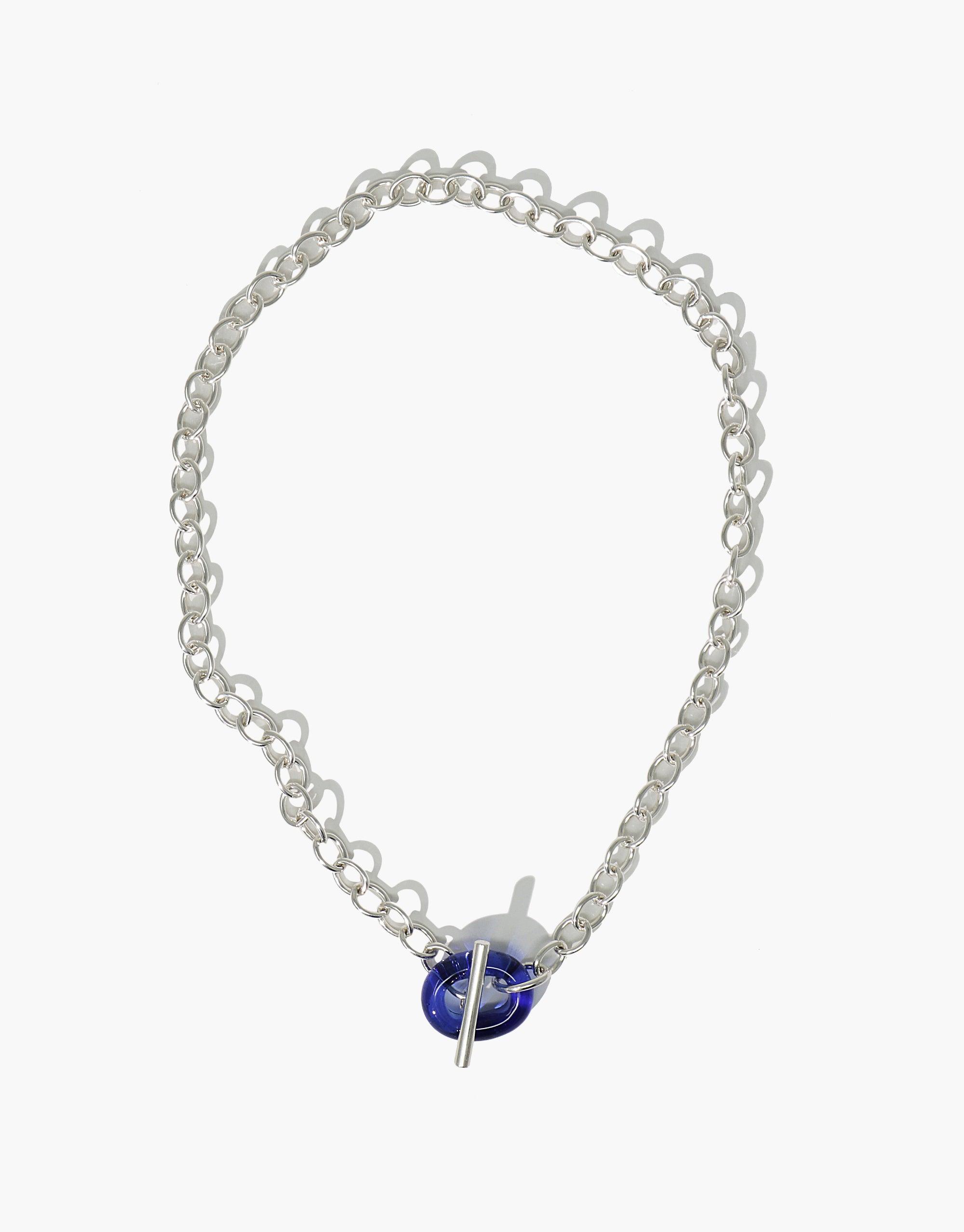 Elegant ITL Toggle Choker Necklace featuring silver interlocking chain links with a blue eco gem toggle closure. Handcrafted sustainable jewelry piece showcasing recycled glass and eco-friendly design. Versatile accessory for various occasions. CLED ITL Toggle Choker Necklace.